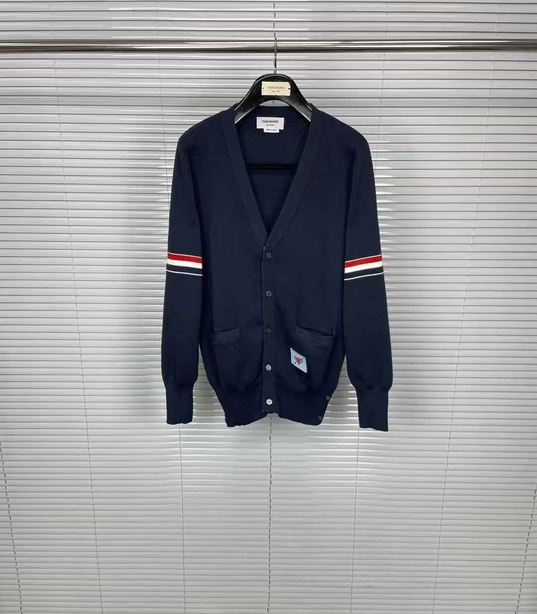 Thom Browne navy blue V-neck cotton cardigan with a signature 4-Bar stripe