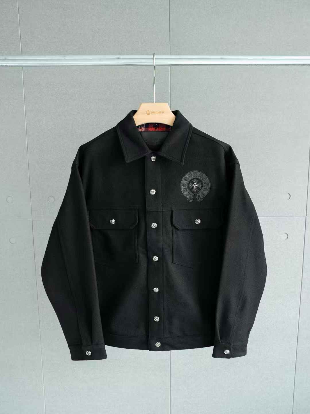 chrome hearts black denim jacket with a circular logo on the chest and silver buttons