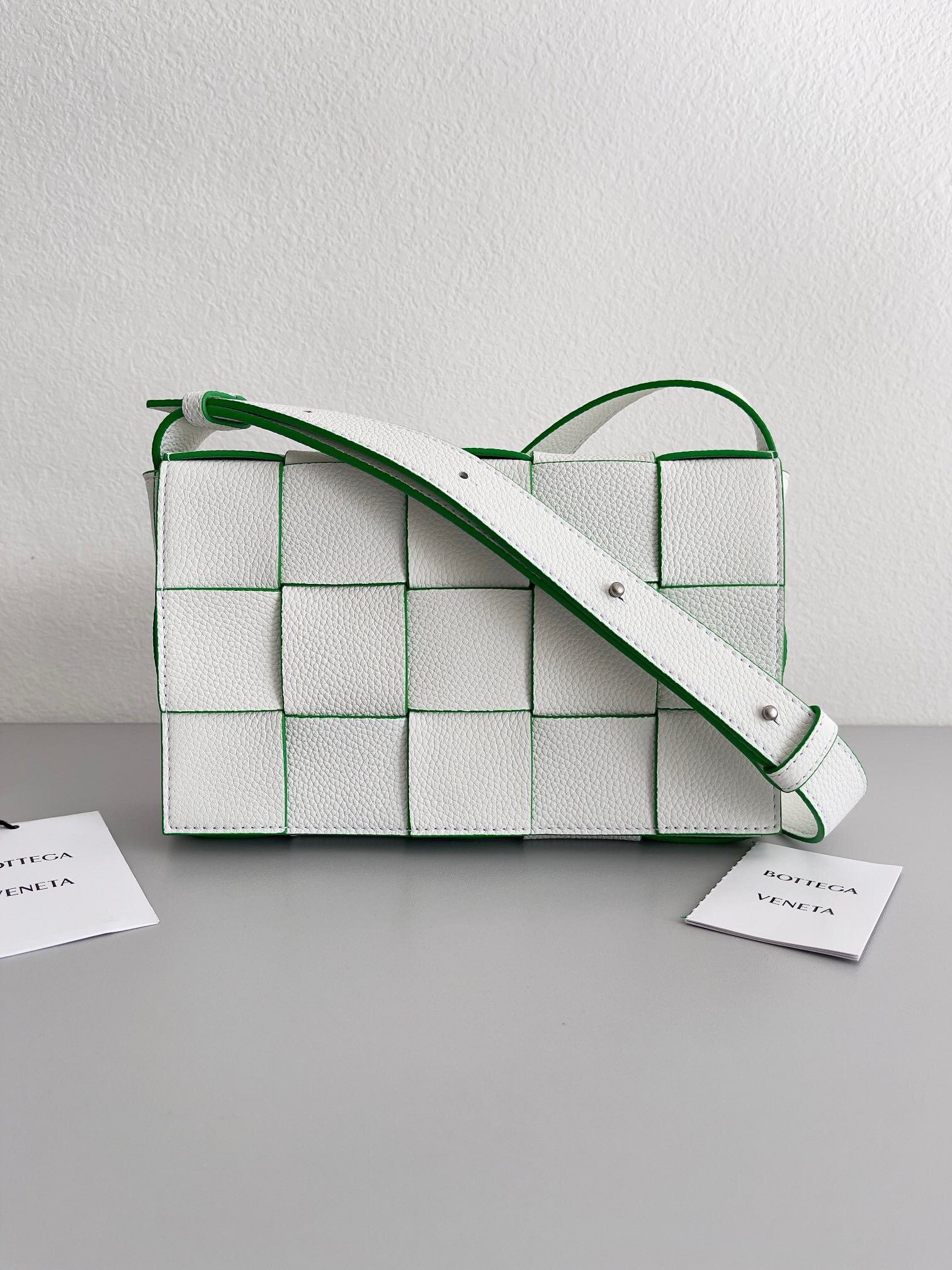 Bottega Veneta Cassette crossbody bag in white with green trim