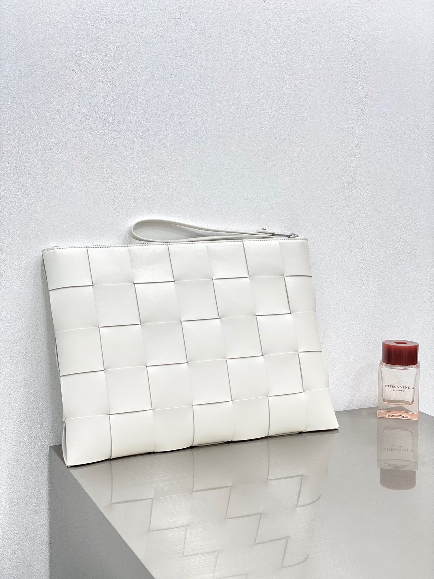 Bottega Veneta Intrecciato leather pouch in white.