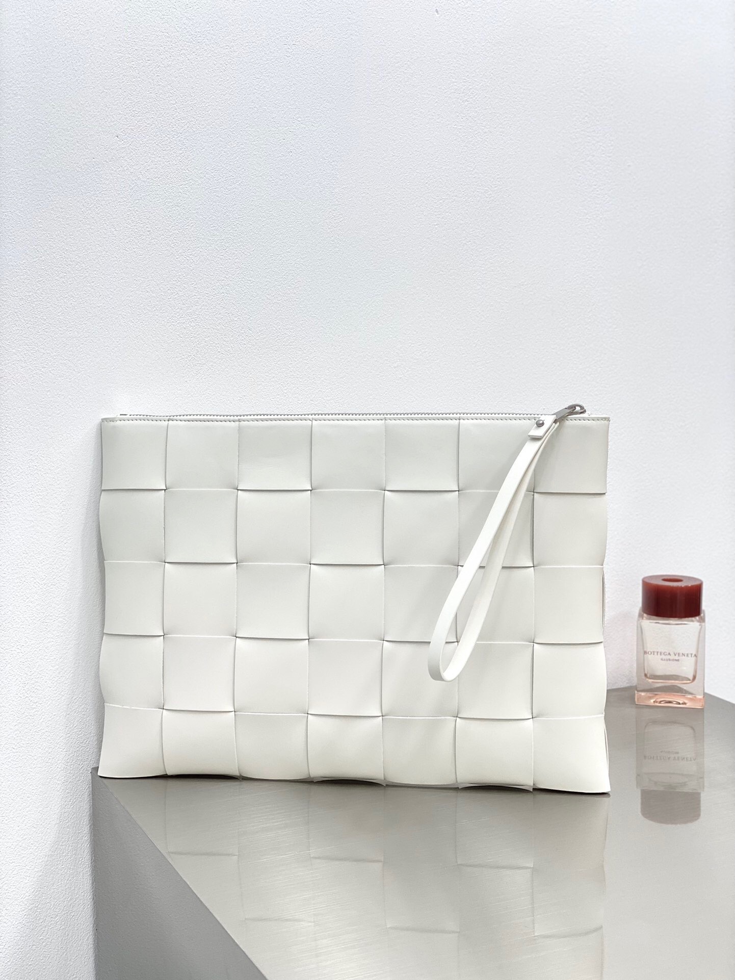 Bottega Veneta Intrecciato leather pouch in white.