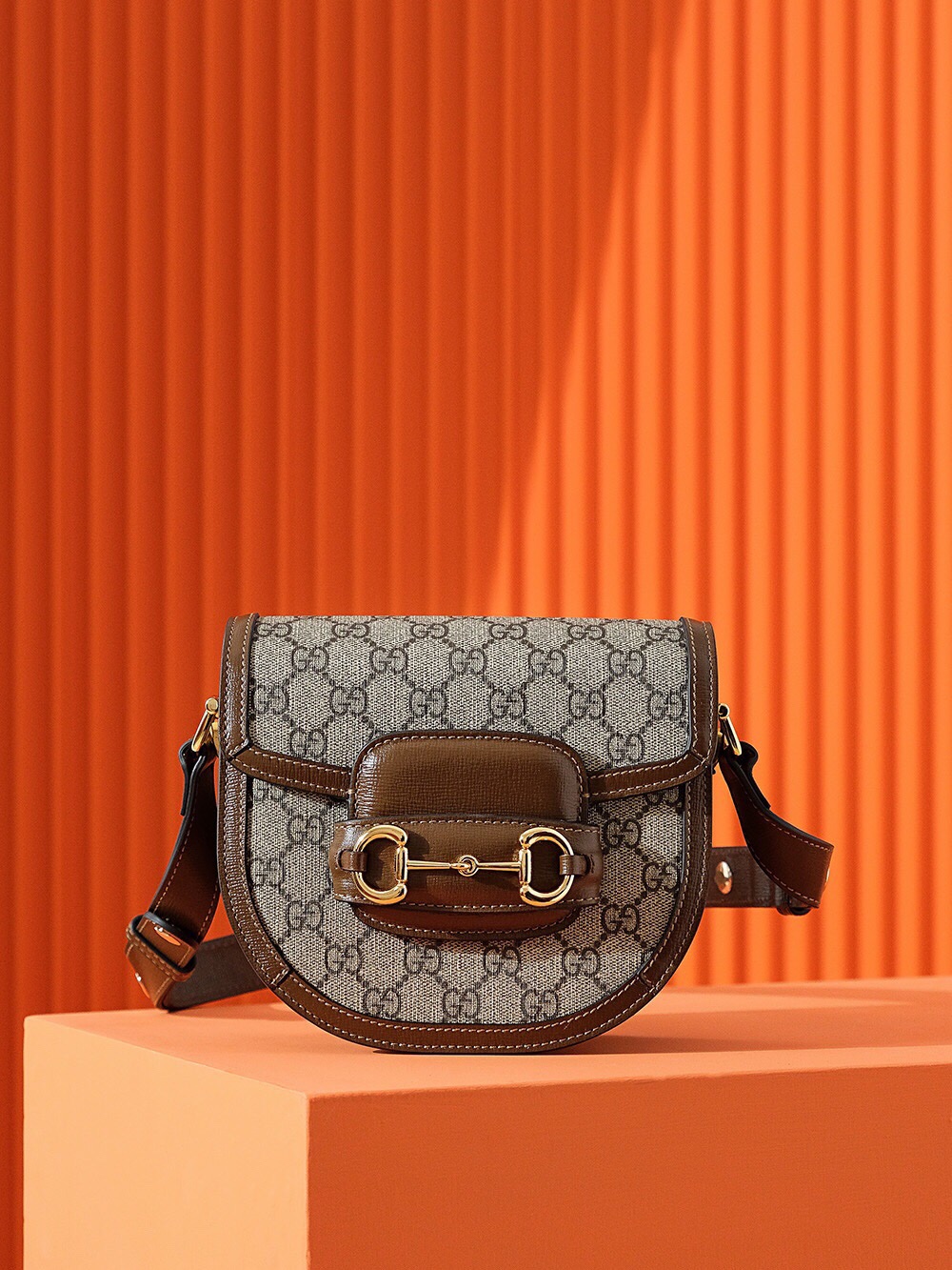 Gucci Horsebit 1955 mini rounded bag in GG Supreme canvas with brown leather trim