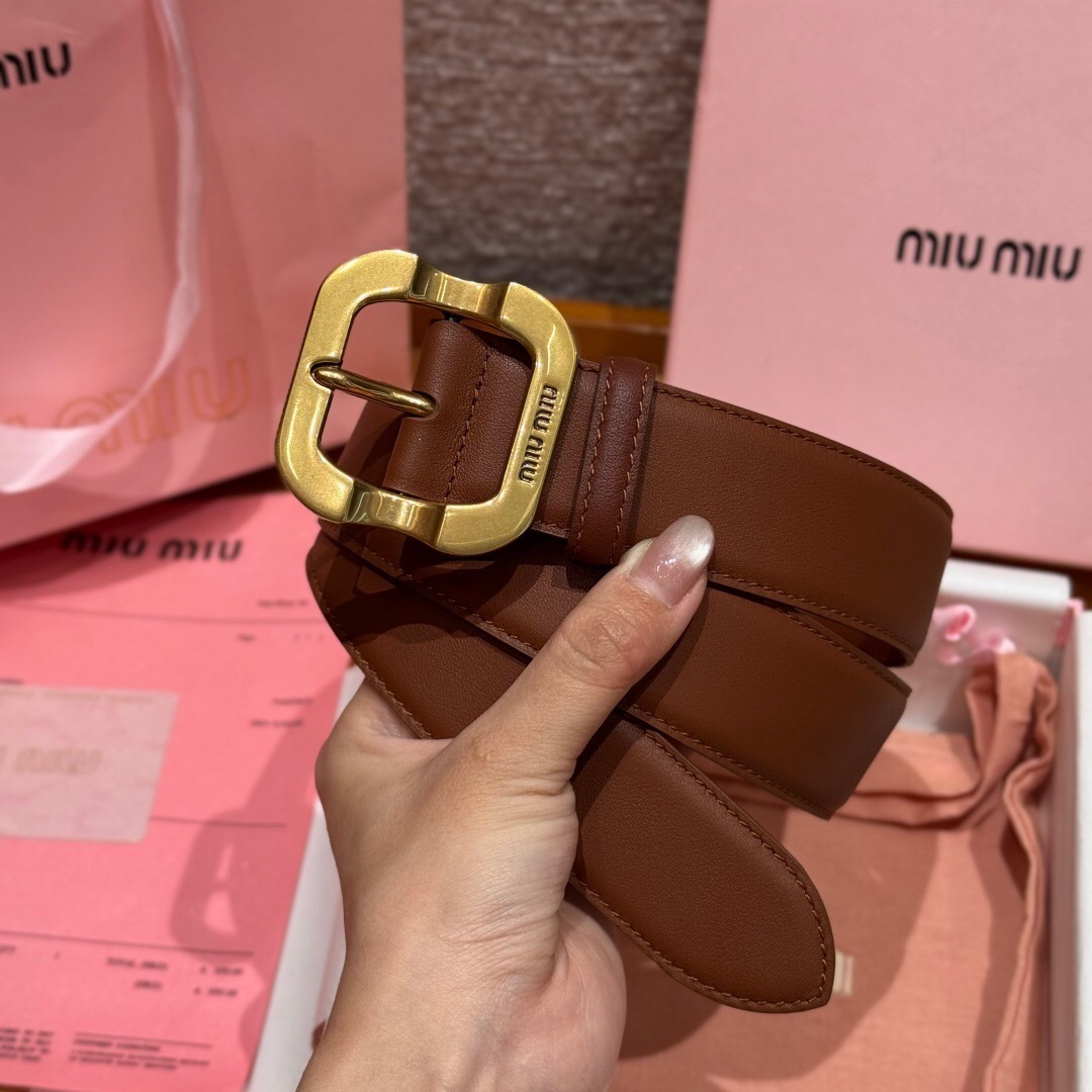 Miu Miu leather belt in a caramel brown color with a gold-tone, logo-engraved buckle.