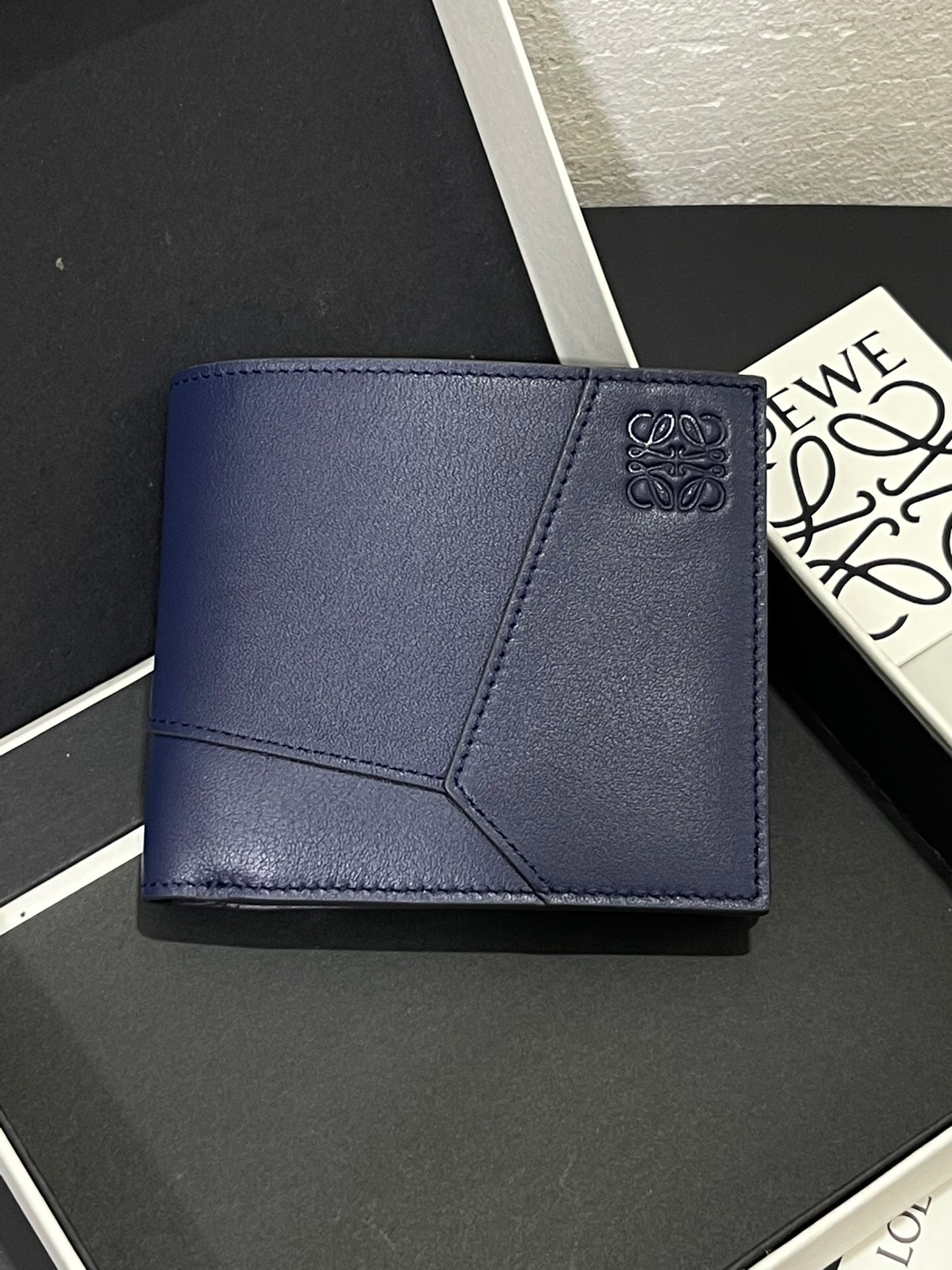 Loewe Puzzle bifold wallet in classic calfskin leather, featuring the signature geometric panel design and an embossed Anagram logo
