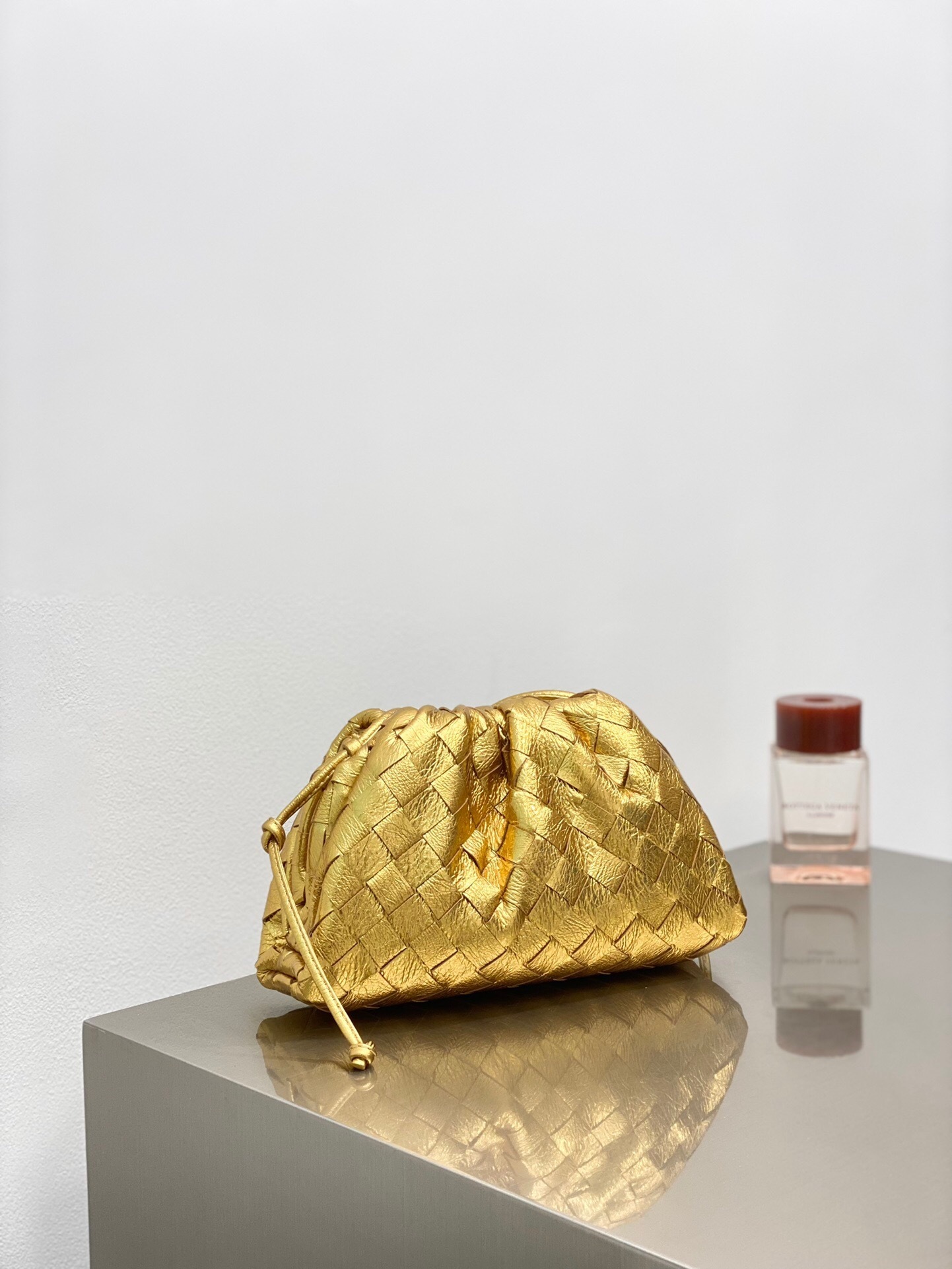 Bottega Veneta Mini Pouch bag in gold intrecciato leather