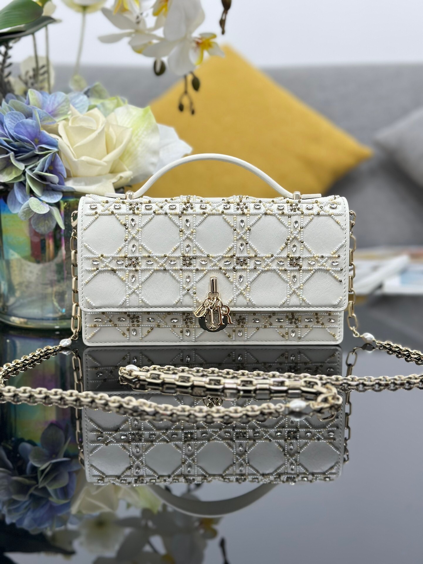Dior Lady Dior mini bag in platinum-colored metallic lambskin, embroidered with a cannage motif in faceted beads