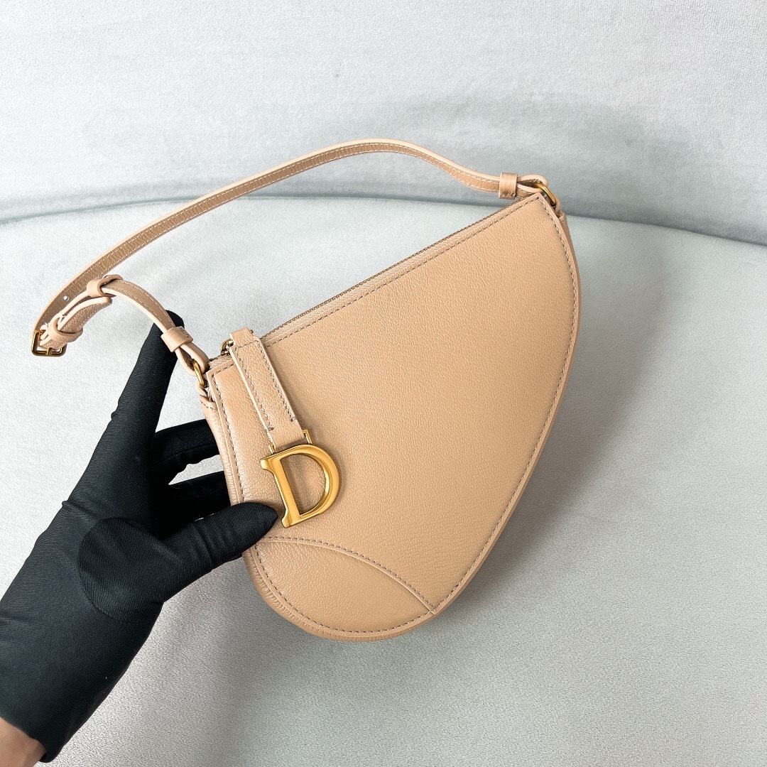 Christian Dior Saddle Rodeo Bag Pouch in a beige or apricot color.
