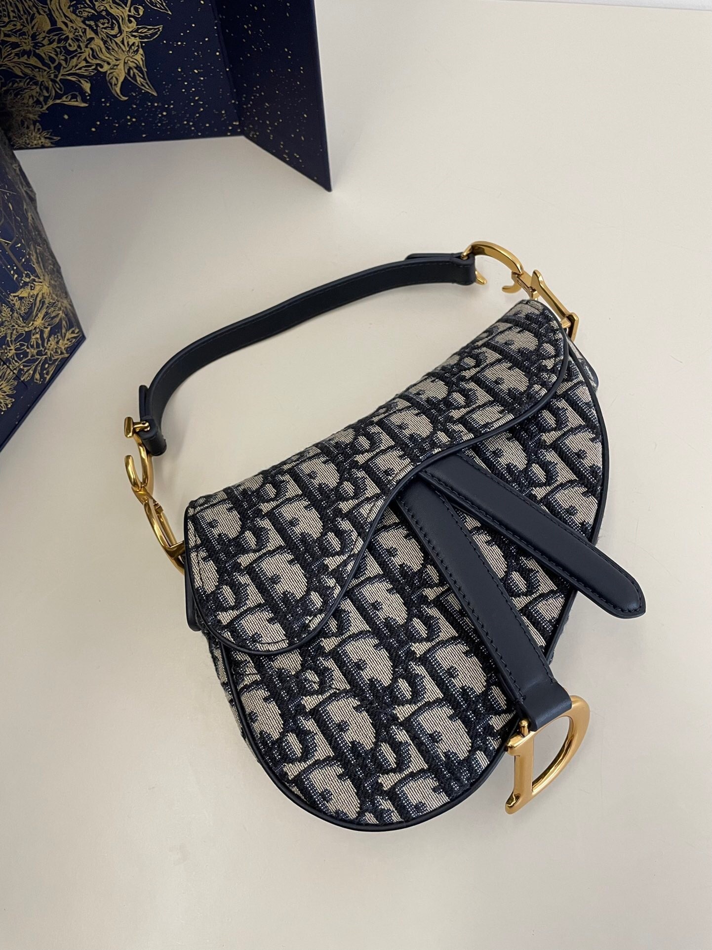 Dior Saddle bag in blue Dior Oblique jacquard with antique gold-finish metal details
