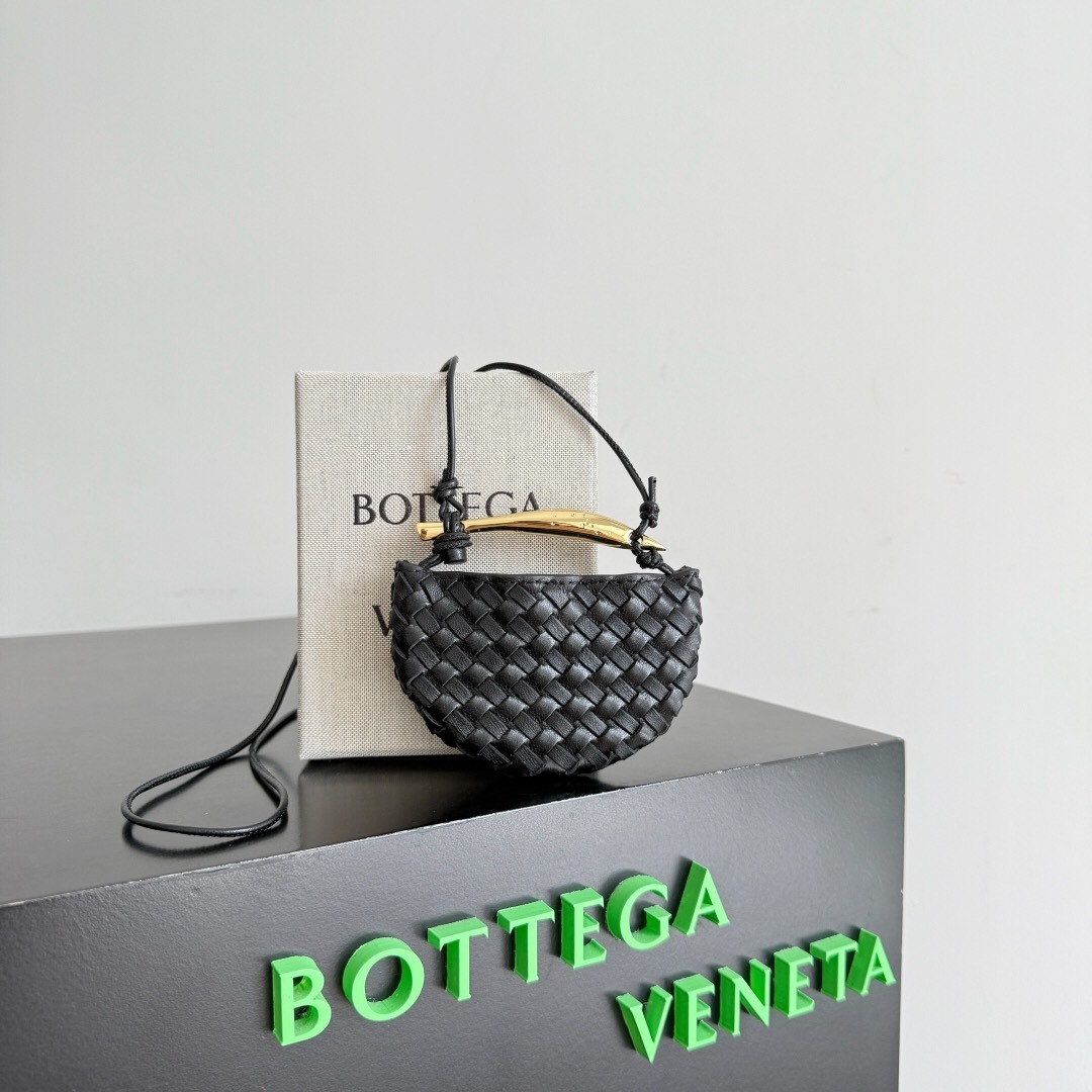 Bottega Veneta Sardine mini intrecciato leather cross-body bag in black with a sculptural metallic top handle