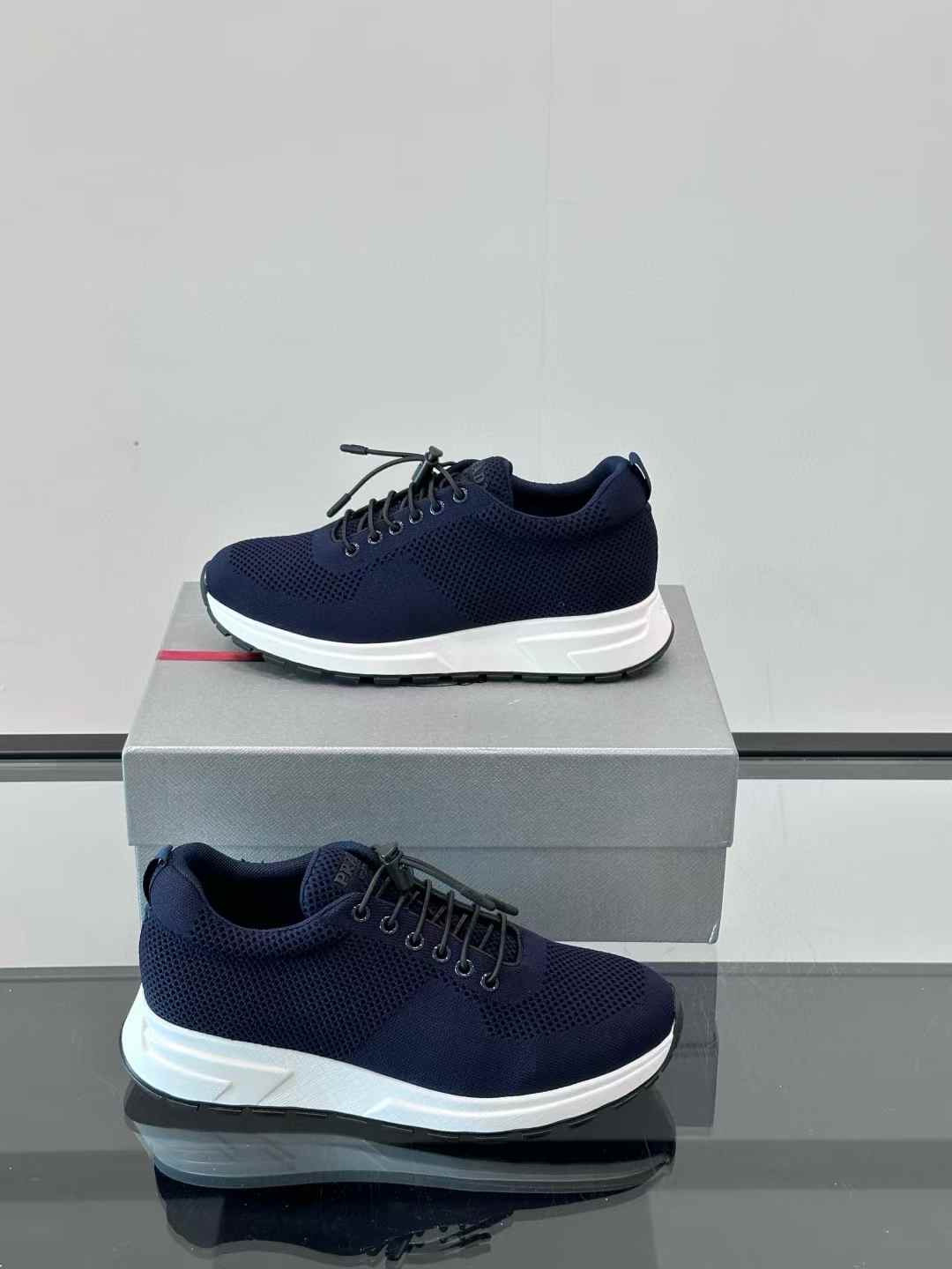 Prada navy blue lace-up sneakers with a white sole