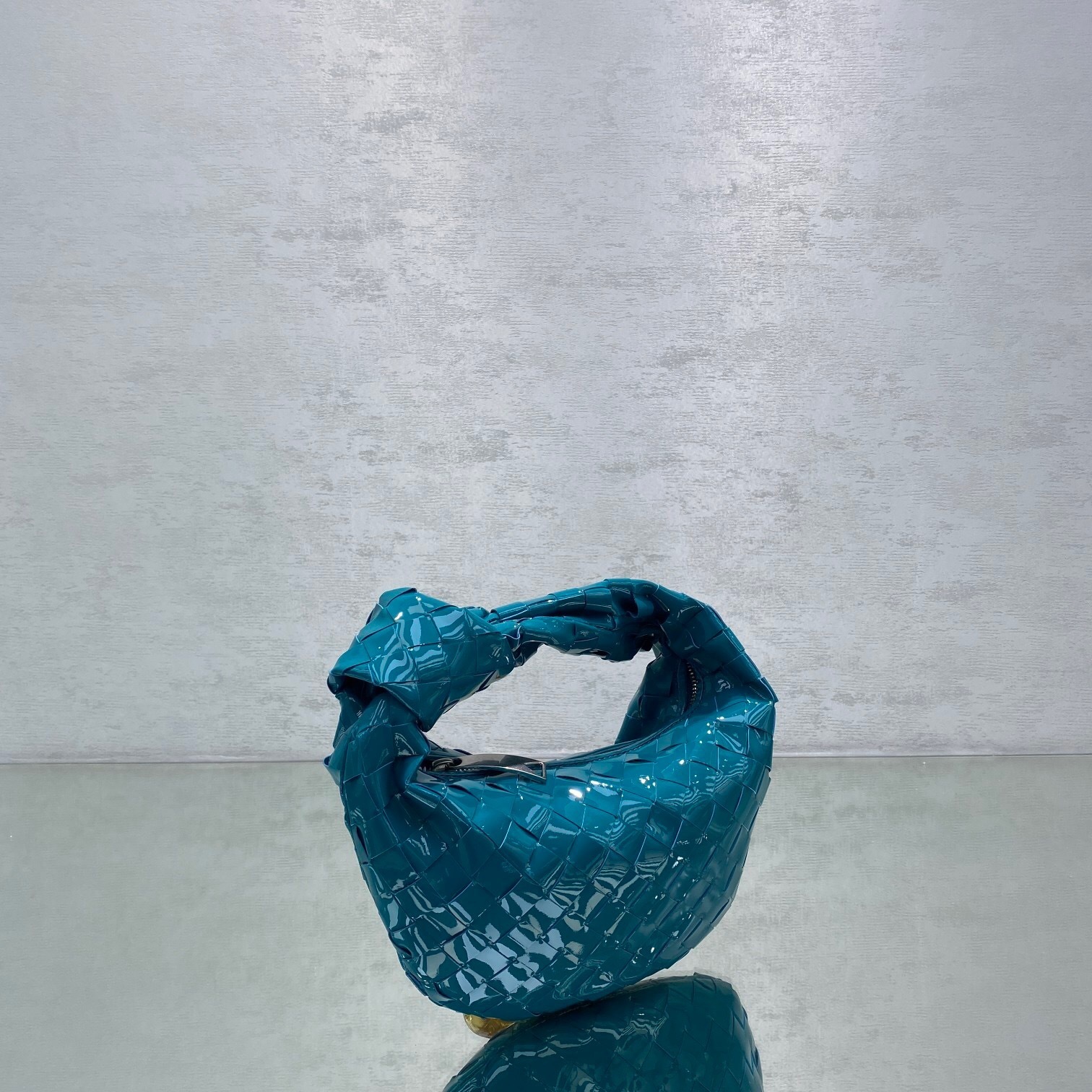 Bottega Veneta Mini Jodie bag in turquoise leather with the signature Intrecciato design