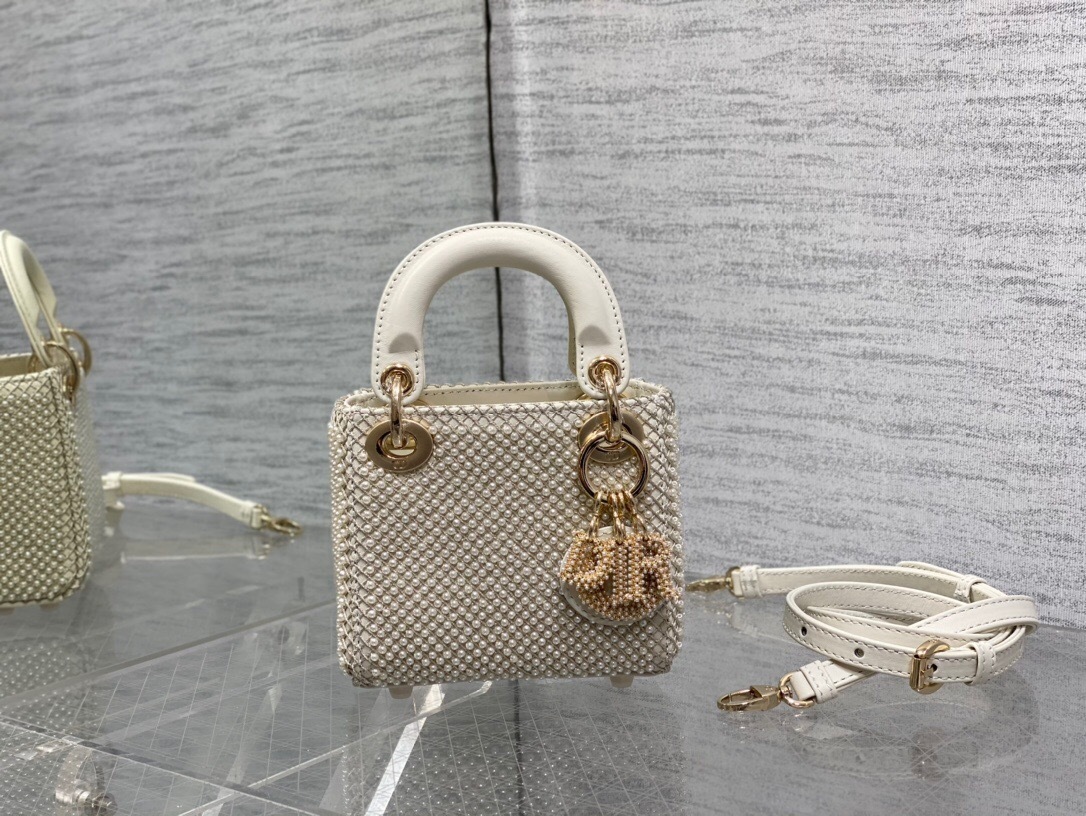 Dior Lady Dior micro bag crafted from latte satin and embroidered with white resin pearls and gold-tone metallic thread