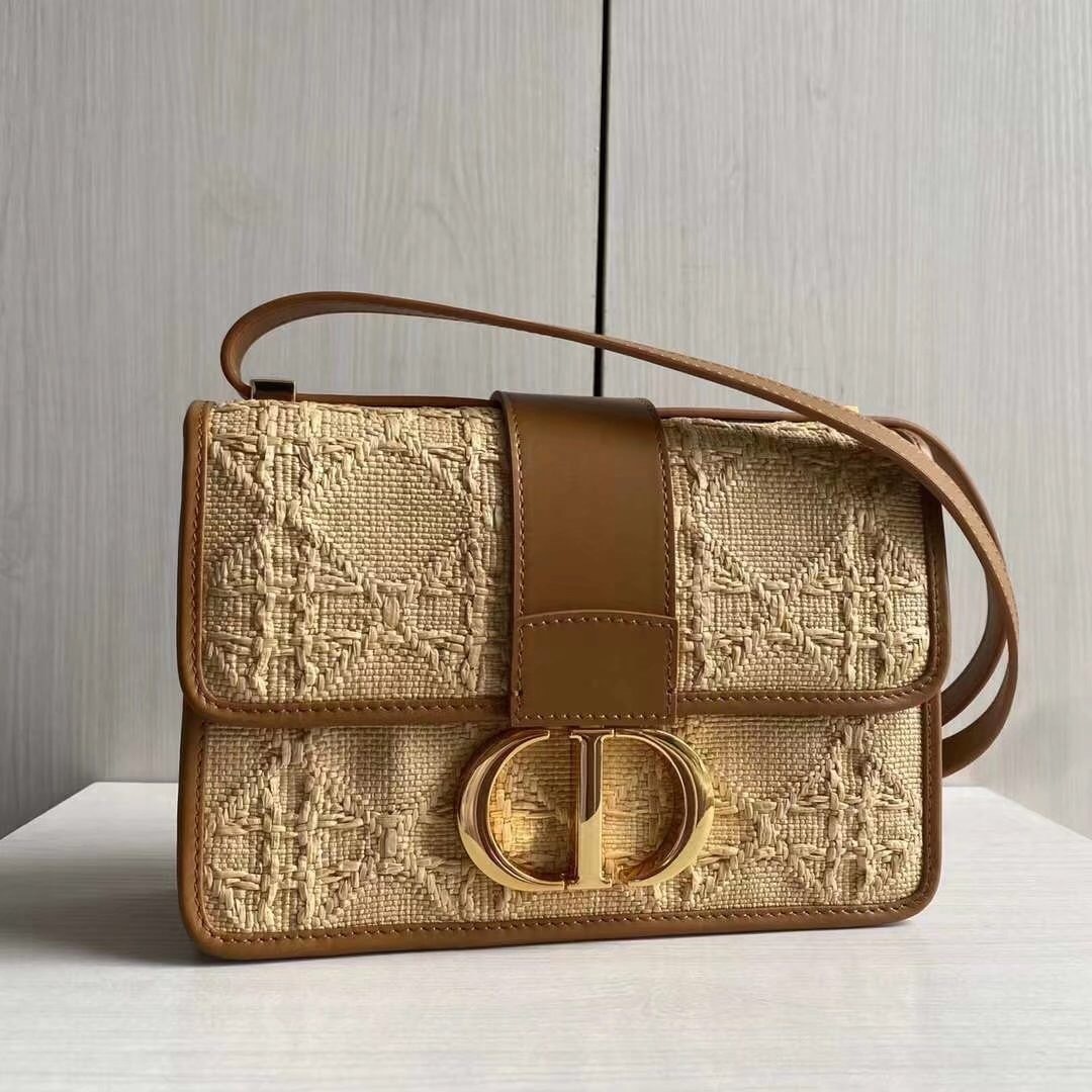 Dior 30 Montaigne bag in natural cannage raffia, featuring a "CD" clasp and a leather shoulder strap.