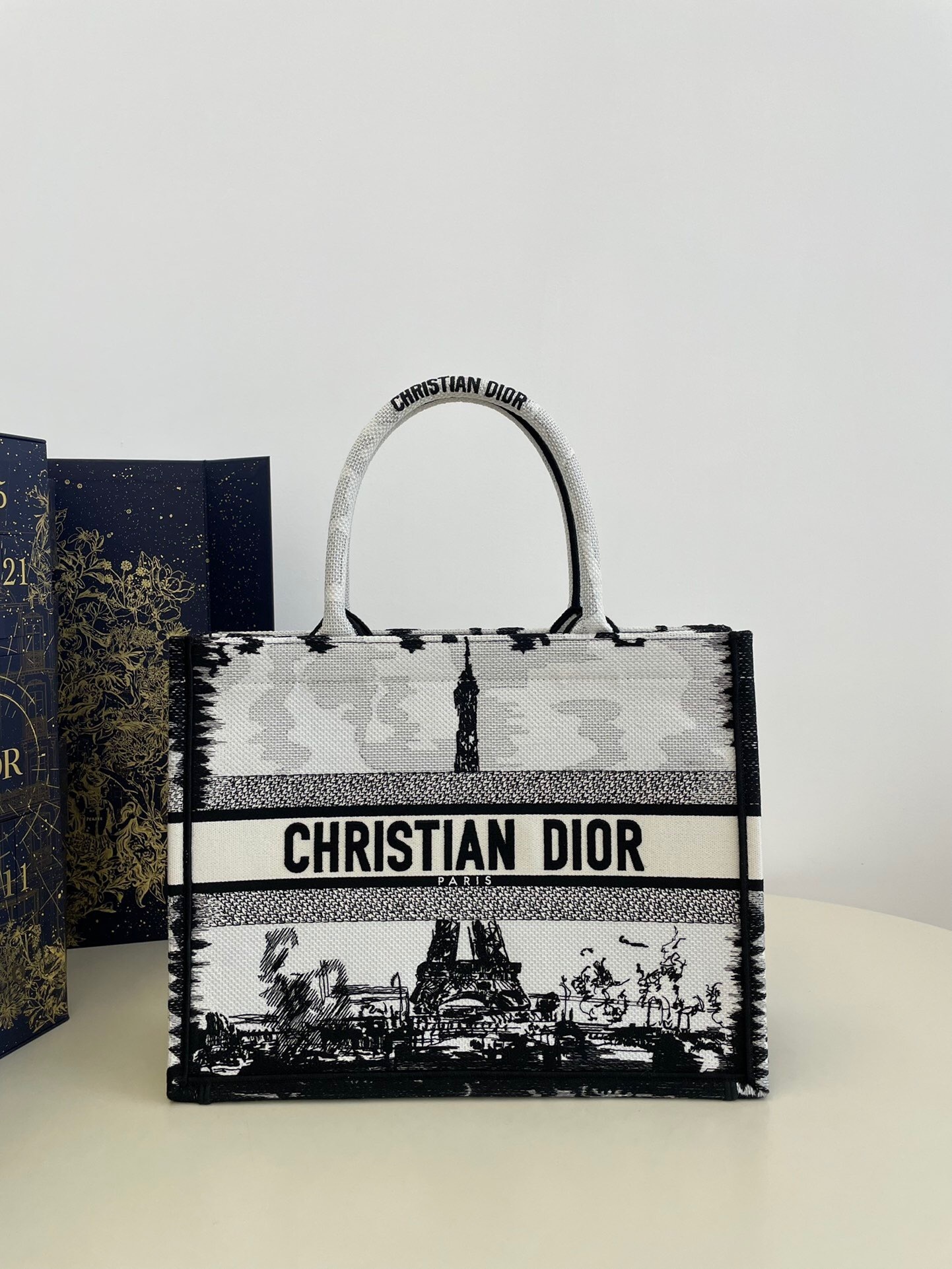 Dior Book Tote bag with a black and white Parisian-themed print featuring the Eiffel Tower