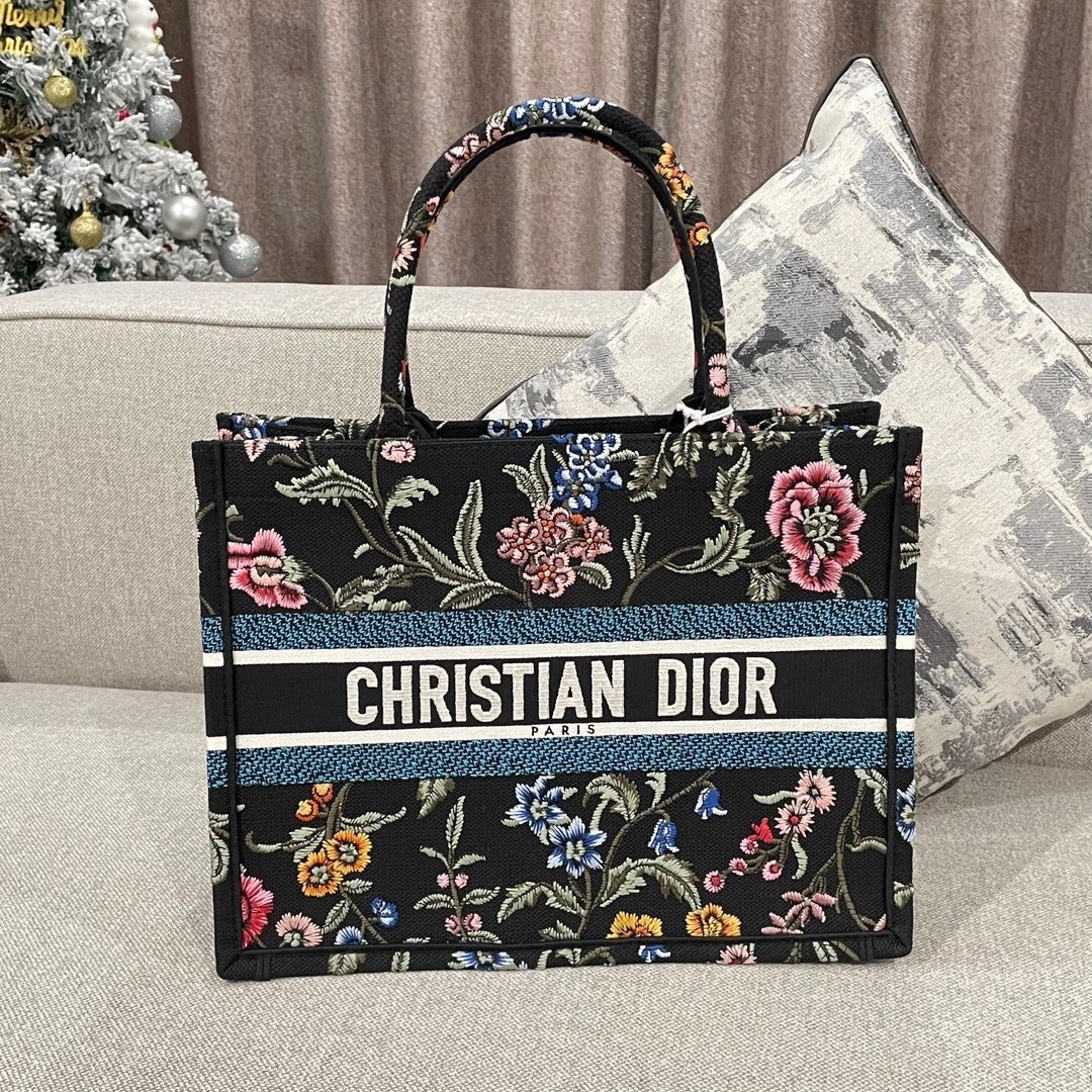 Dior Book Tote, featuring a black background with a multi-colored floral embroidery pattern