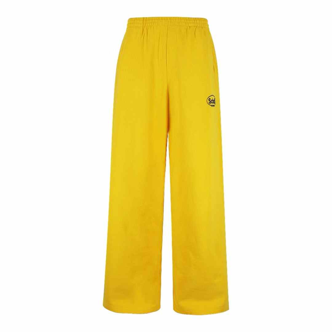 Balenciaga x Scholl logo-embroidered pants in yellow. `