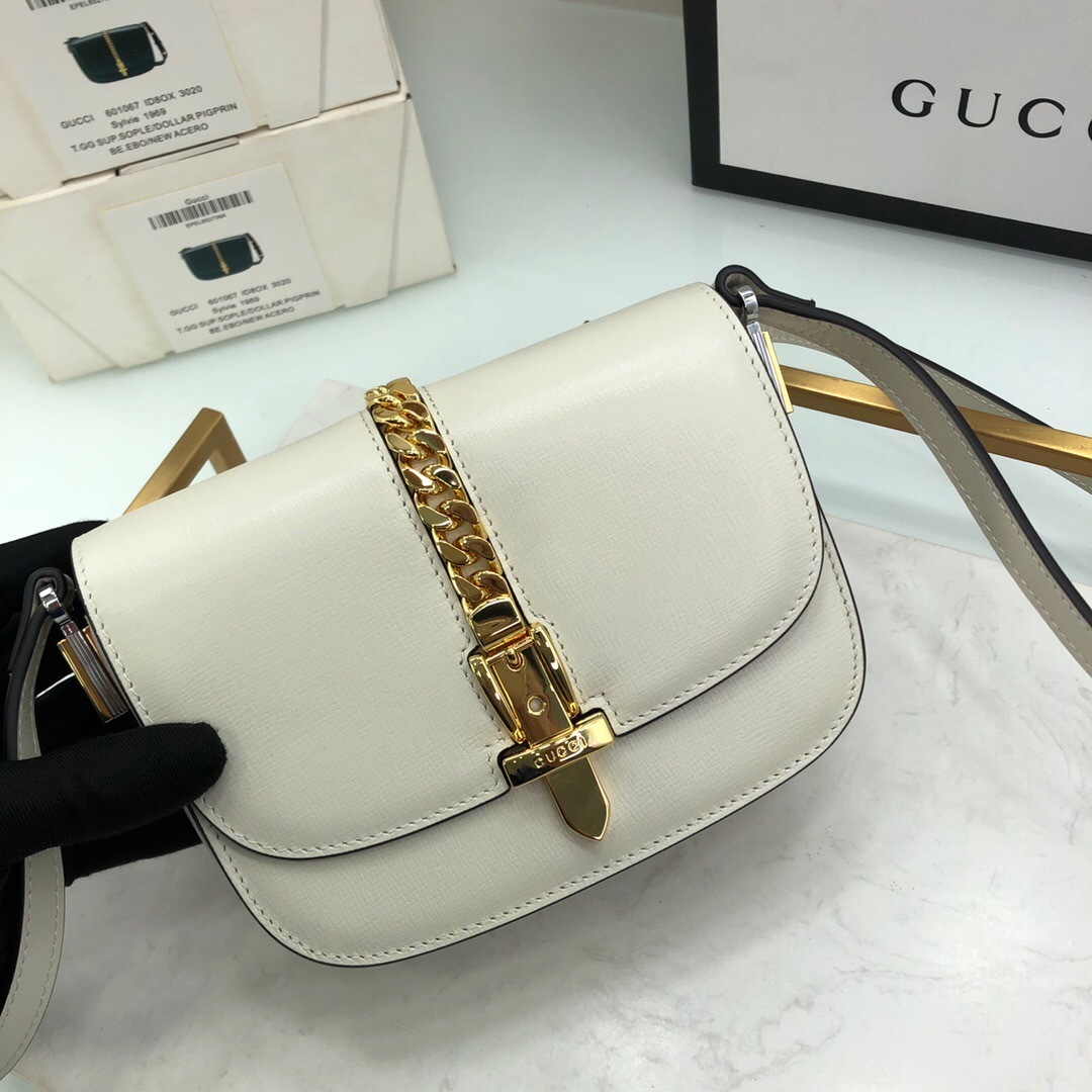 Gucci Sylvie 1969 mini shoulder bag in white leather with a gold-toned chain and buckle closure