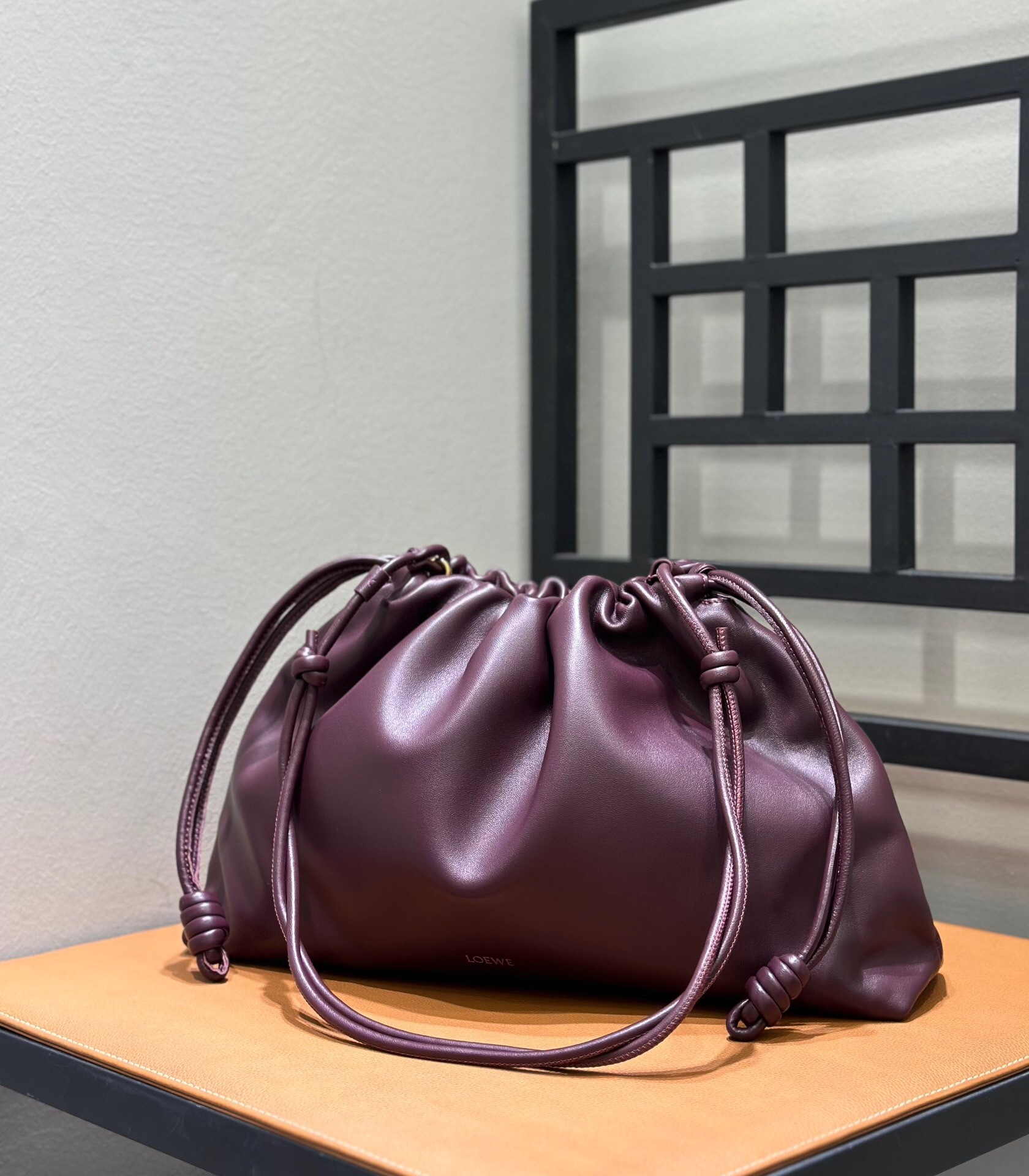 Loewe Flamenco large bag in soft bordeaux nappa lambskin leather with signature coiled knots.