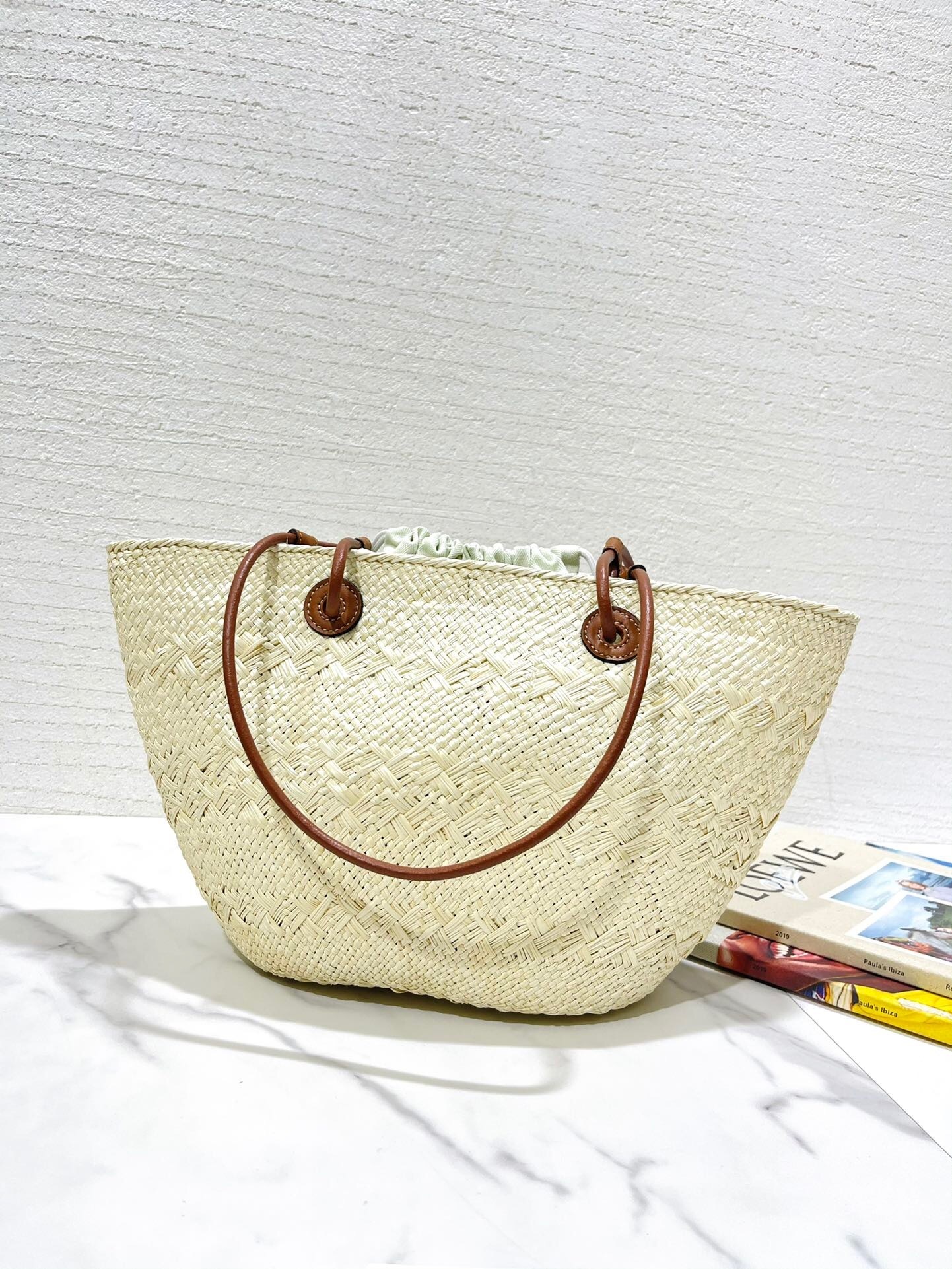 Loewe x Paula's Ibiza Anagram small bucket bag in natural iraca palm and tan calfskin