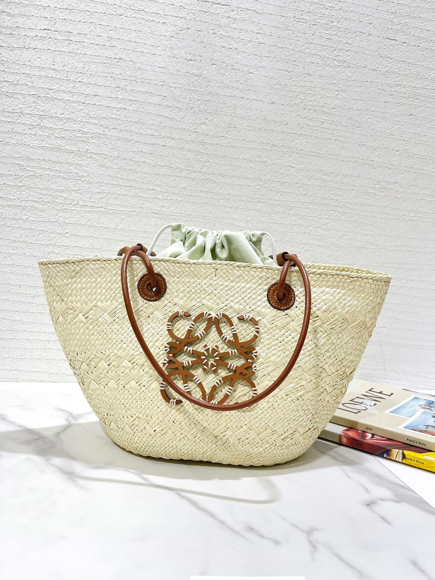 Loewe x Paula's Ibiza Anagram small bucket bag in natural iraca palm and tan calfskin