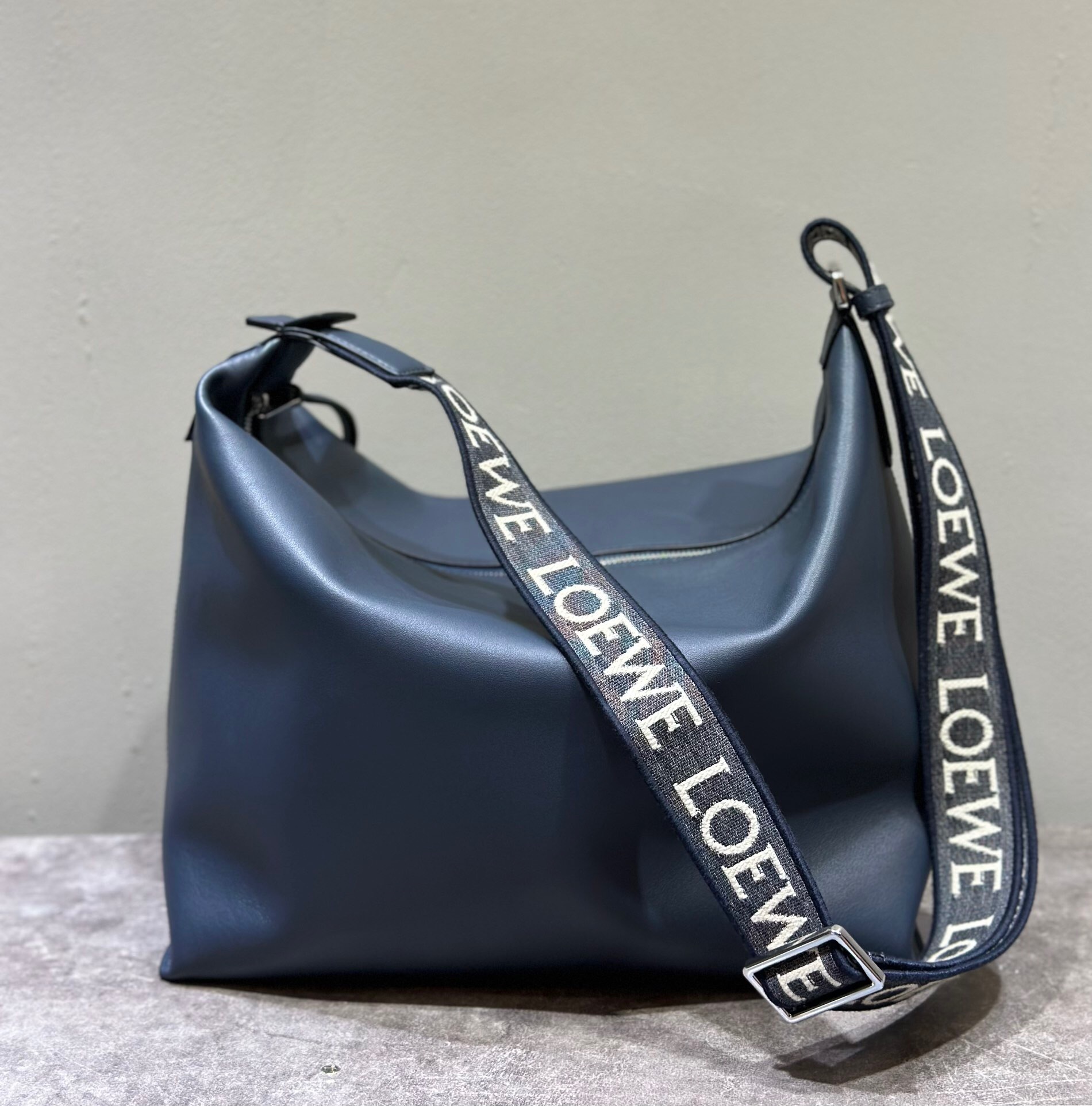 Loewe Cubi crossbody bag in navy blue supple smooth calfskin leather with a logo-jacquard strap