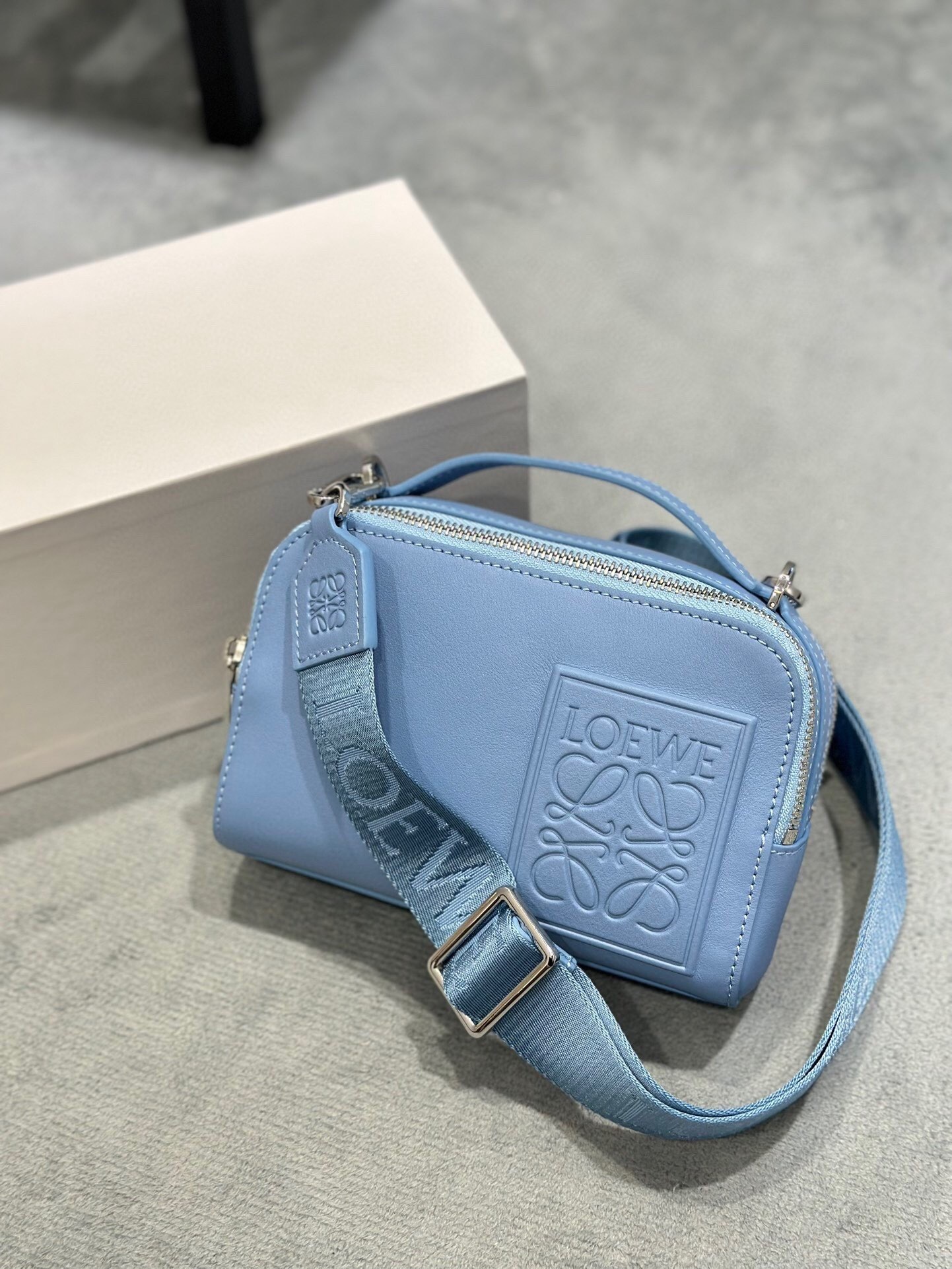 Loewe Mini Camera crossbody bag in soft grained calfskin leather and a light blue color