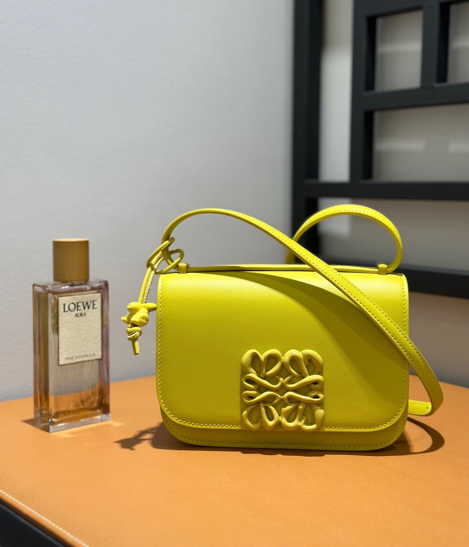 Loewe Goya bag in a vibrant yellow color with an inflated Anagram closure