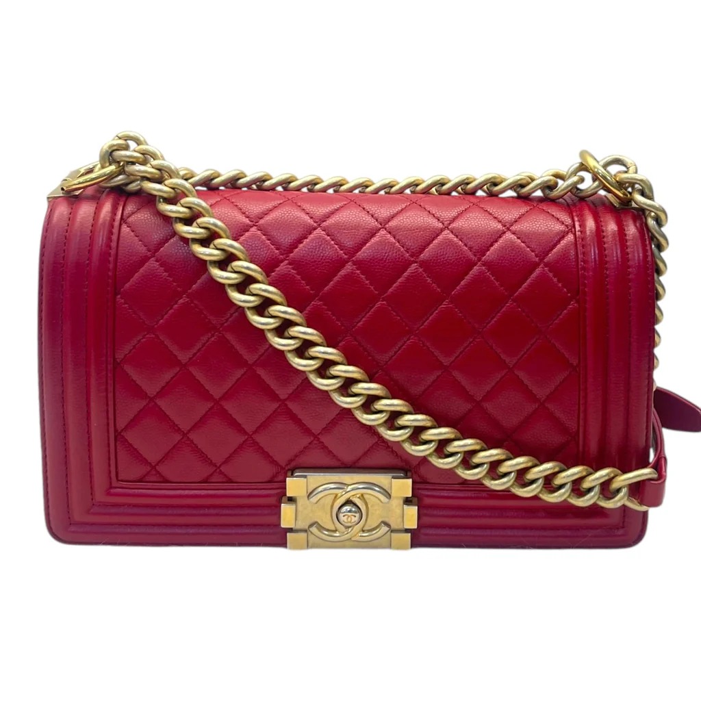 Chanel Boy Flap Bag in red lambskin leather with a gold-tone chain strap and clasp