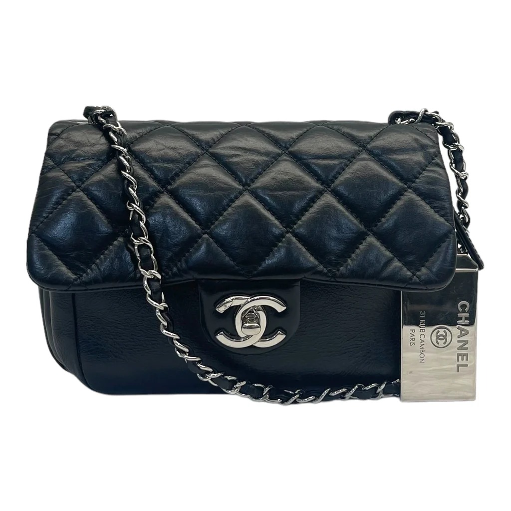Chanel Timeless Classic Flap Bag in black quilted leather with a chain-link strap and a CC turn-lock closure