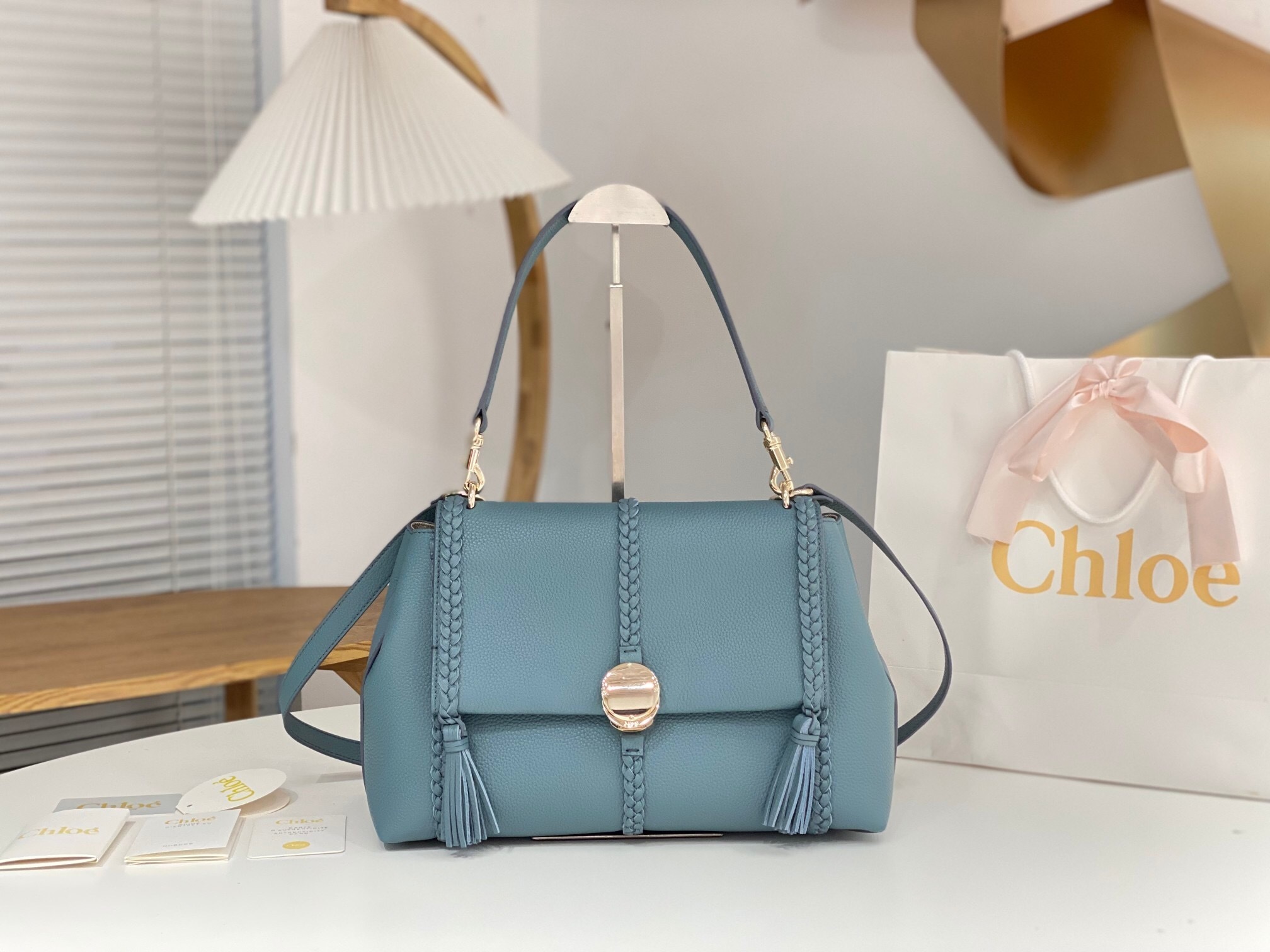 Chloé Penelope medium soft shoulder bag in blue calf leather with braided leather details and tassels