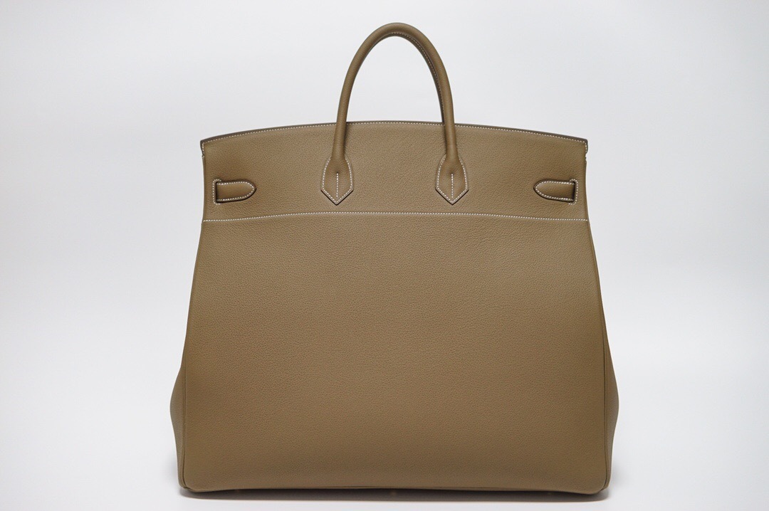 Hermes Birkin bag in a neutral color such as etoupe or gold, featuring gold-tone hardware