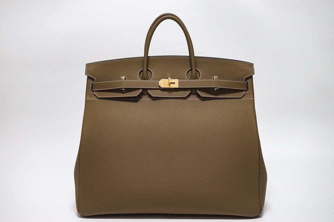 Hermes Birkin bag in a neutral color such as etoupe or gold, featuring gold-tone hardware
