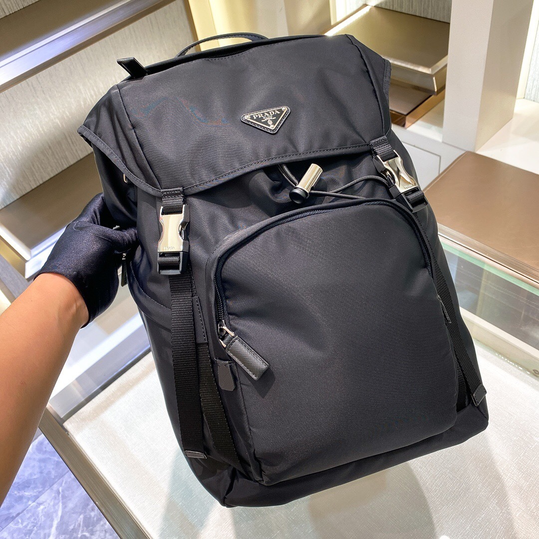 Prada Re-Nylon backpack featuring Saffiano leather trim and the iconic enameled triangle logo Black