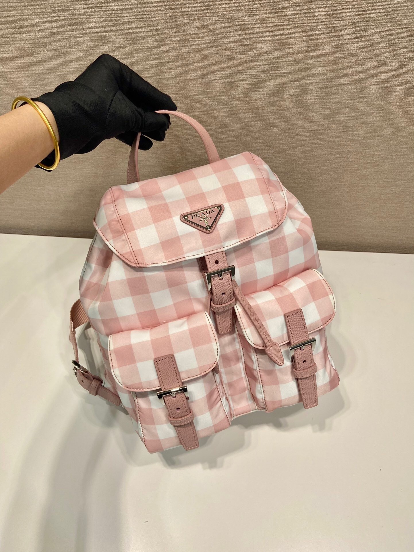 Prada small Re-Nylon backpack in a pink and white gingham print