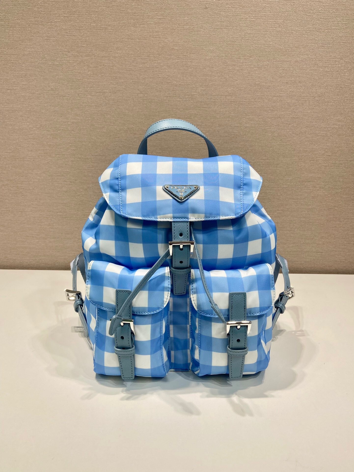 Prada small Re-Nylon backpack in a blue and white gingham print