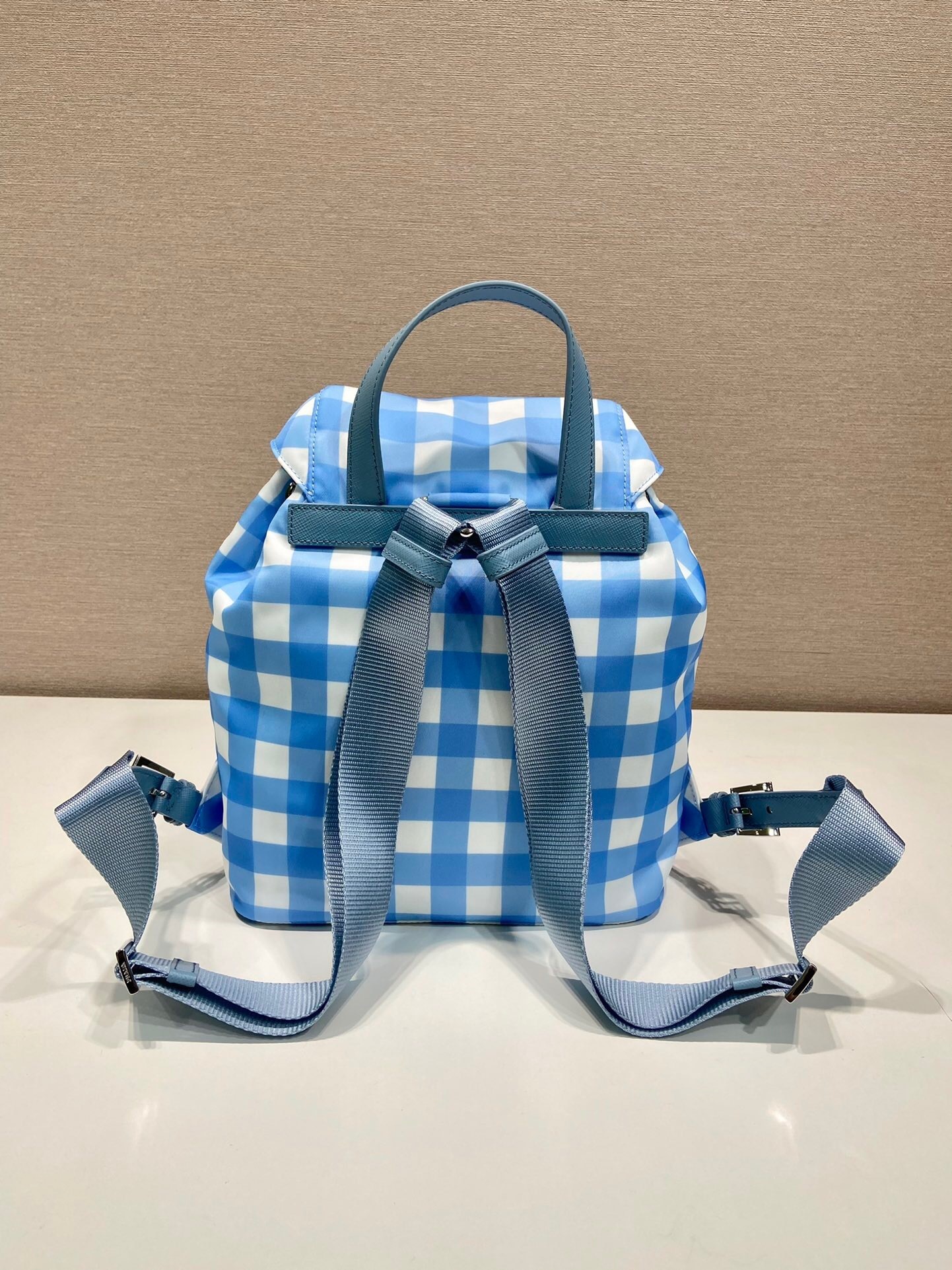Prada small Re-Nylon backpack in a blue and white gingham print