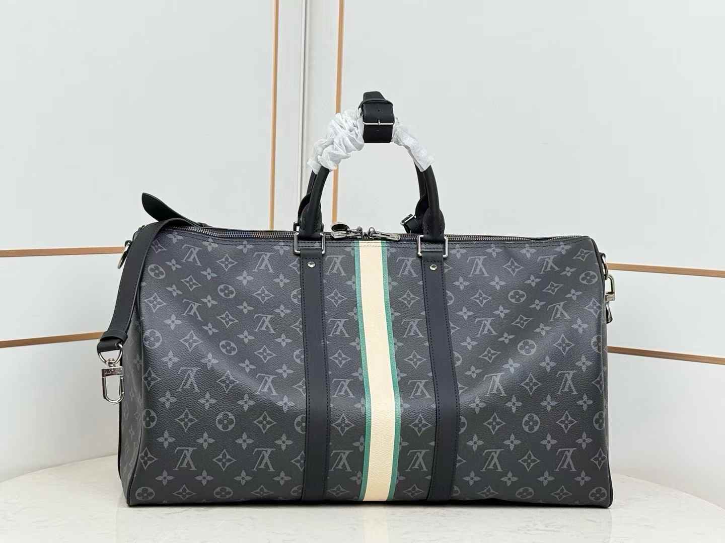LV Keepall Bandoulière 50 travel bag in Monogram Eclipse canvas with a white and green central stripe