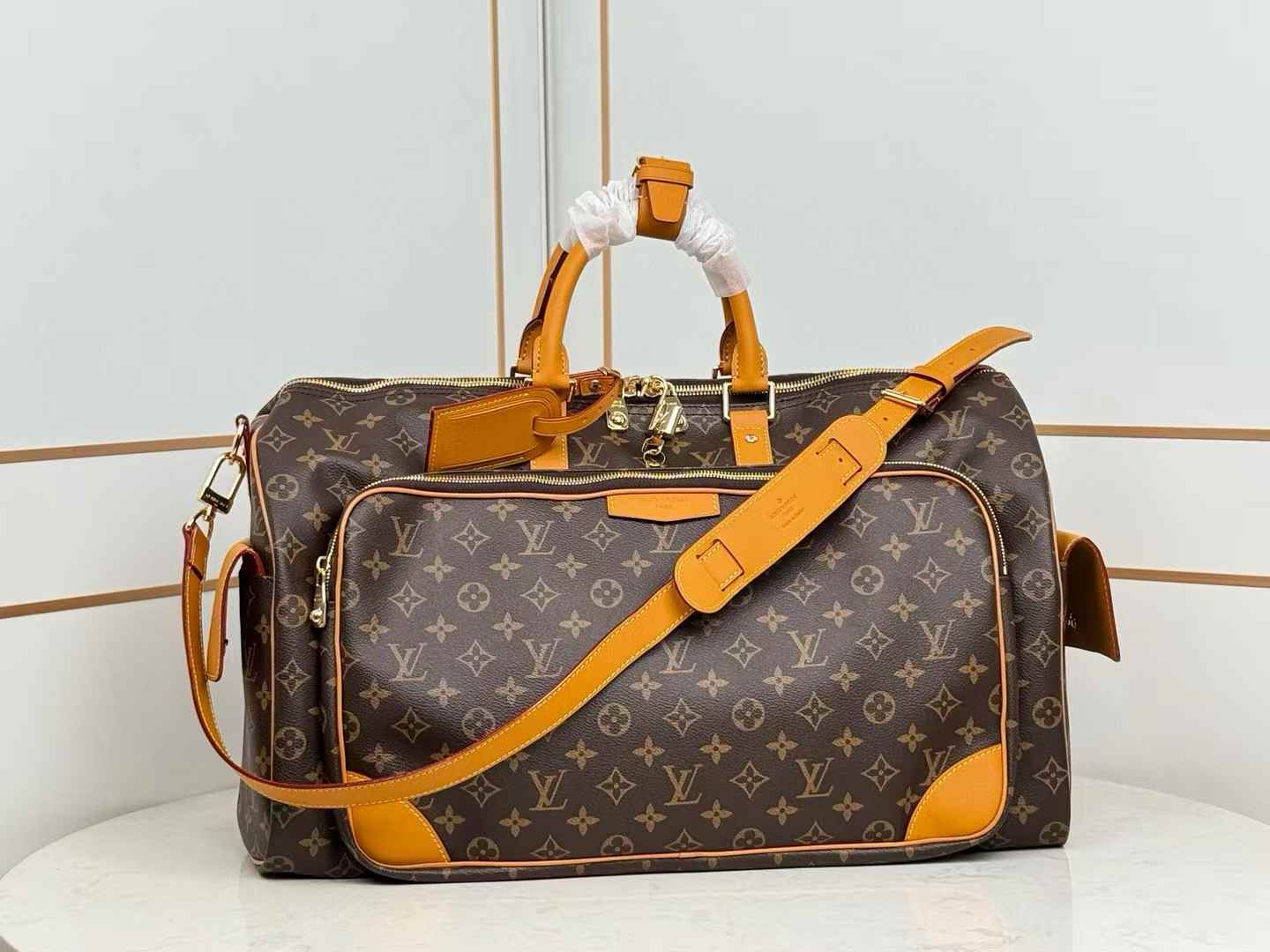 LV Keepall Cargo 50 travel bag in Monogram coated canvas with aged natural-cowhide trim and gold-toned hardware