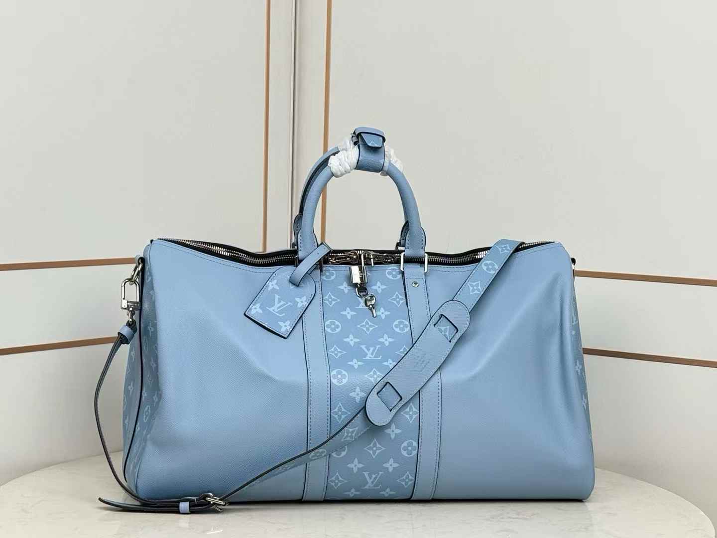 LV Keepall Bandoulière 50 duffle bag in light blue Taurillon leather with an embossed Monogram pattern
