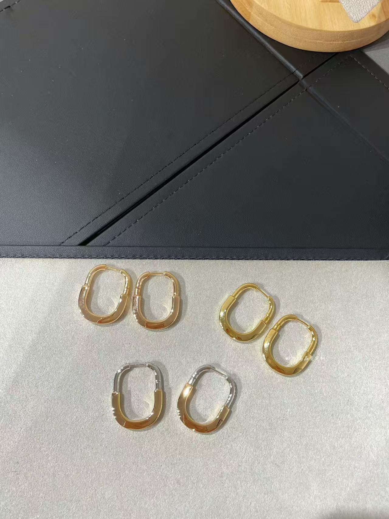 cartier a pair of gold-toned hoop earrings with diamond accents