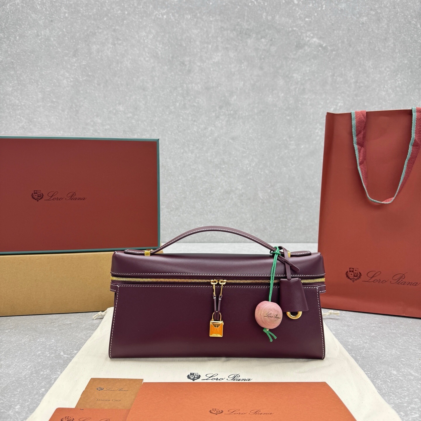 Loro Piana Extra Bag Vanity Case in smooth calfskin with a lock charm and a vintage-inspired keychain