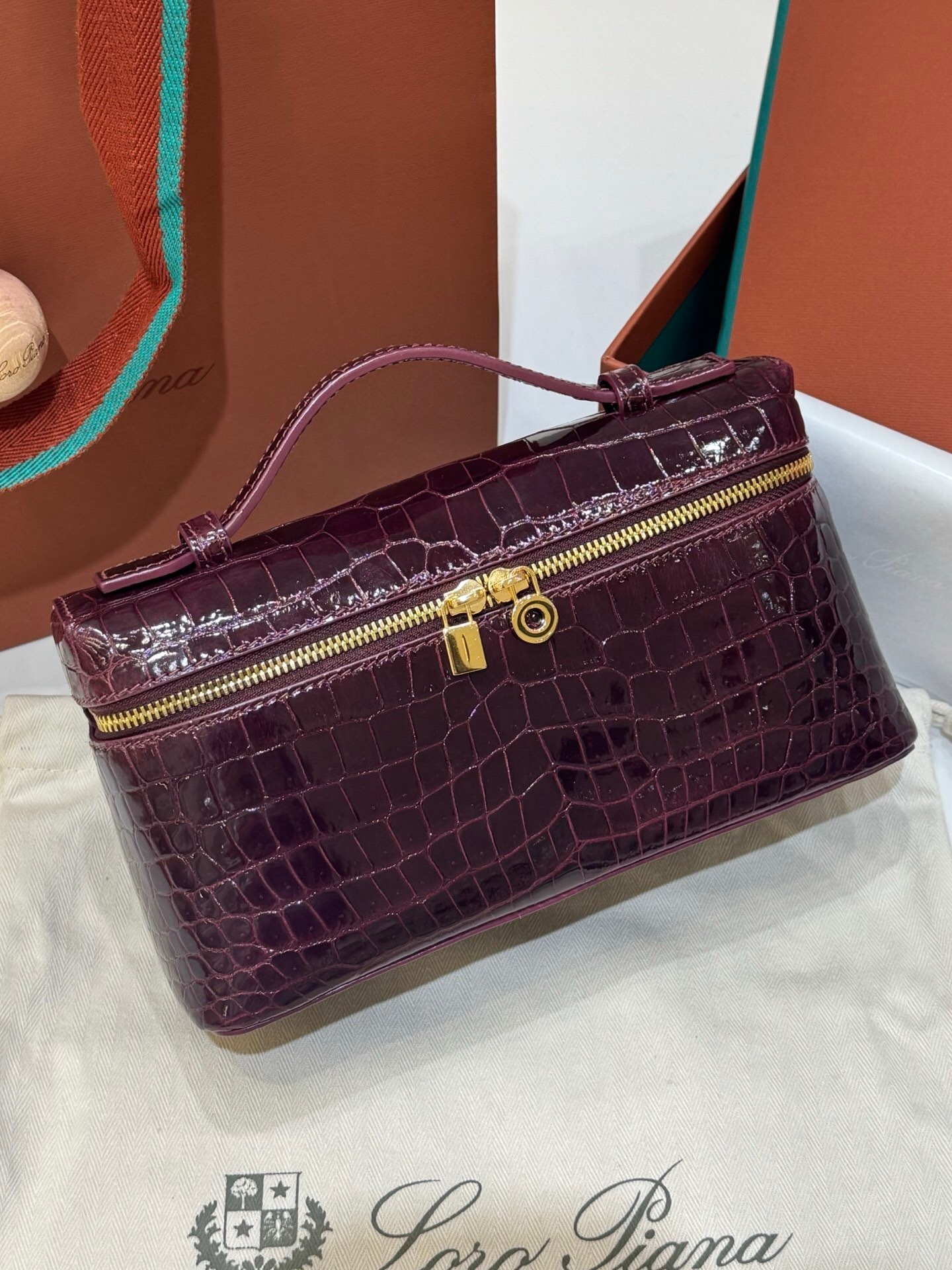 Loro Piana Extra Pocket L19 bag in a purple/burgundy crocodile or alligator material