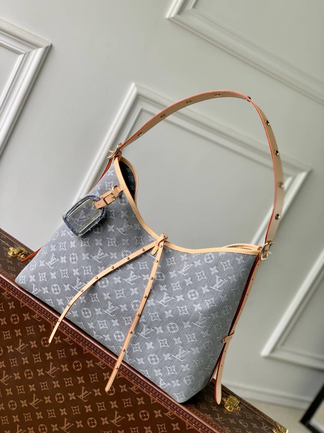 LV CarryAll MM handbag in the Monogram Empreinte leather, featuring a casual-chic hobo style and an adjustable shoulder strap