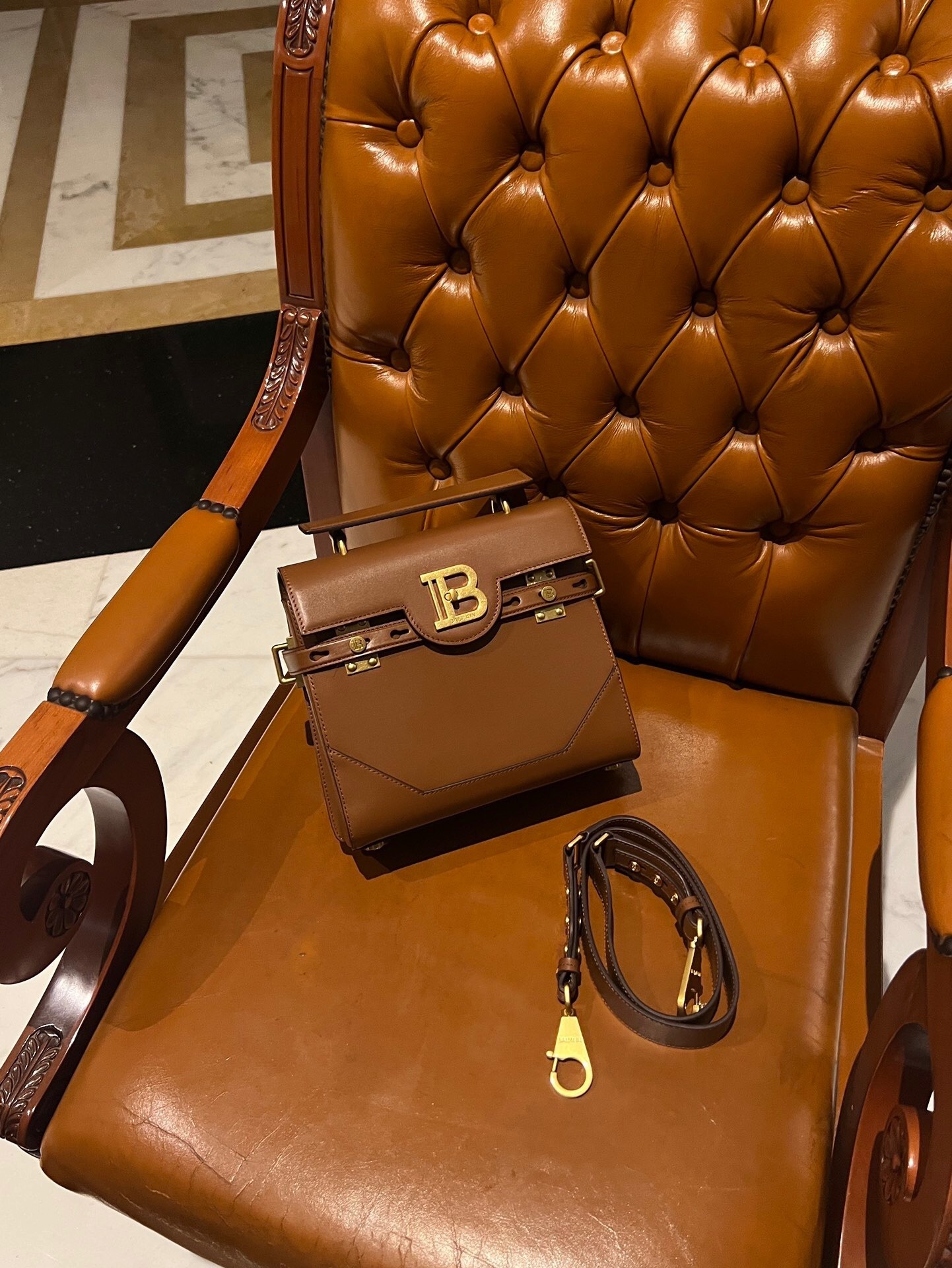 Balmain B-Buzz 23 smooth leather bag in brown with a quarter-turn B-Twist clasp and golden hardware