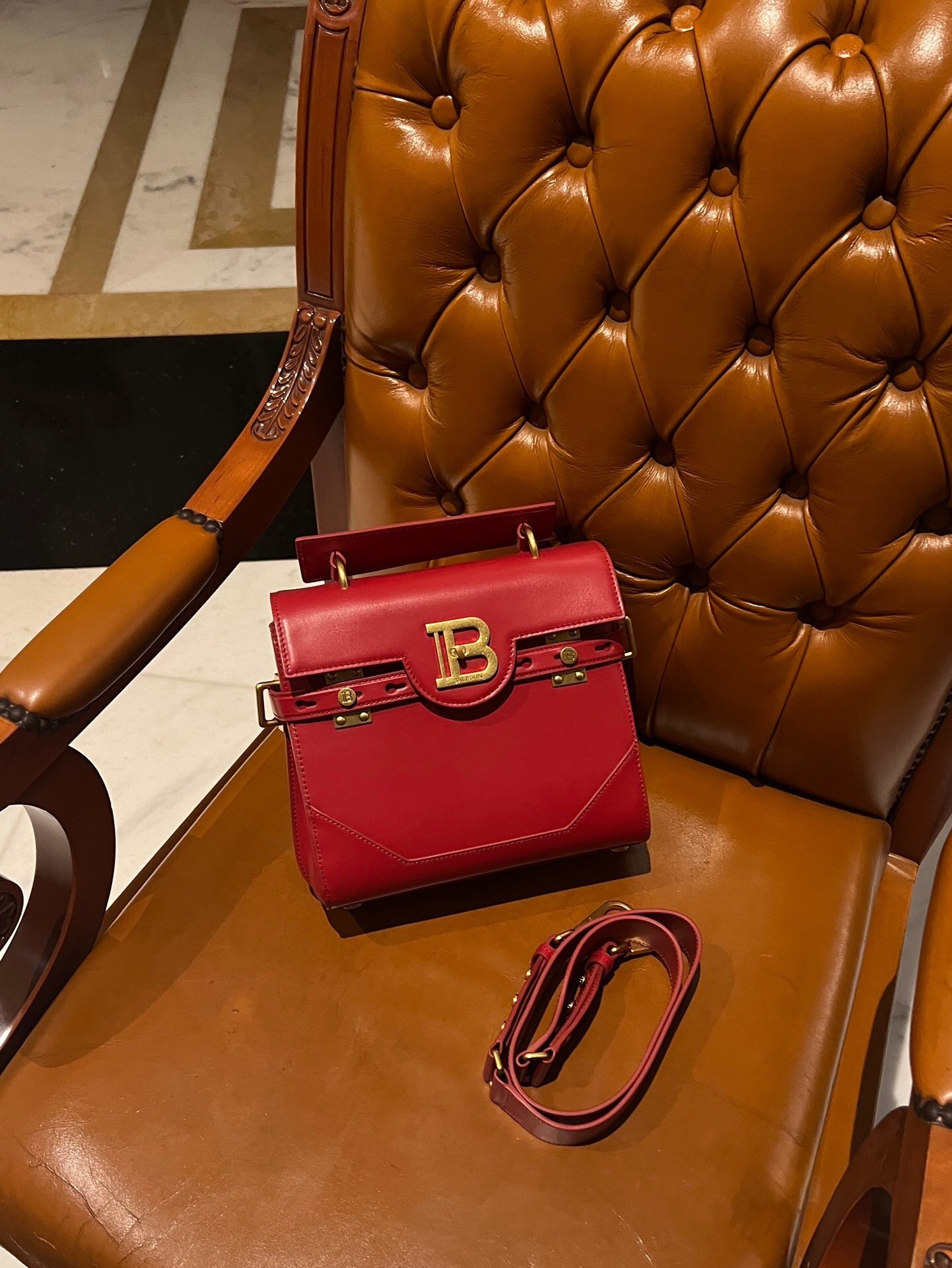 Balmain B-Buzz 23 leather shoulder bag in red with gold-tone hardware and a signature 'B' motif clasp