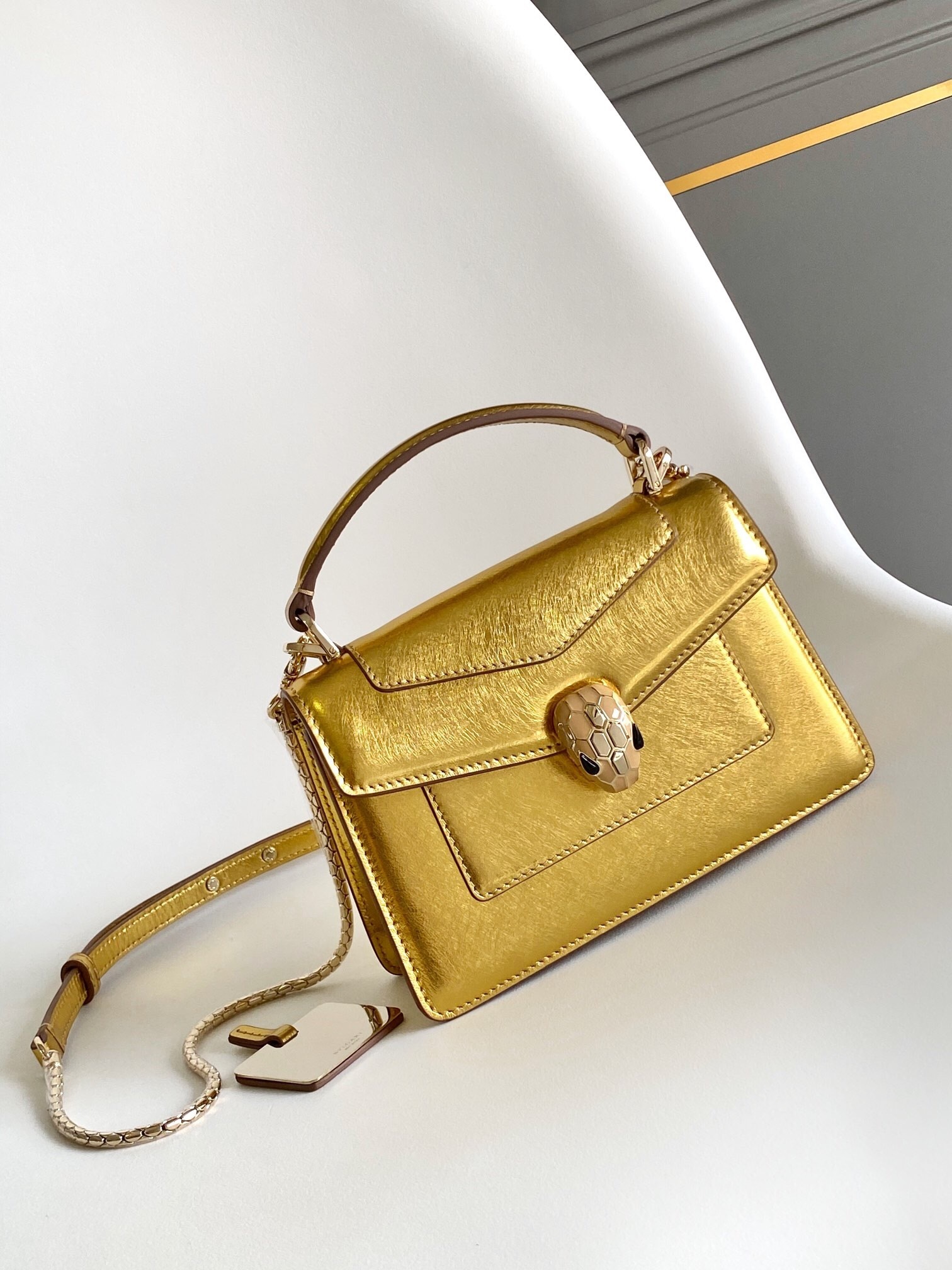 Bvlgari Serpenti Forever mini top handle bag in light gold striated calf leather