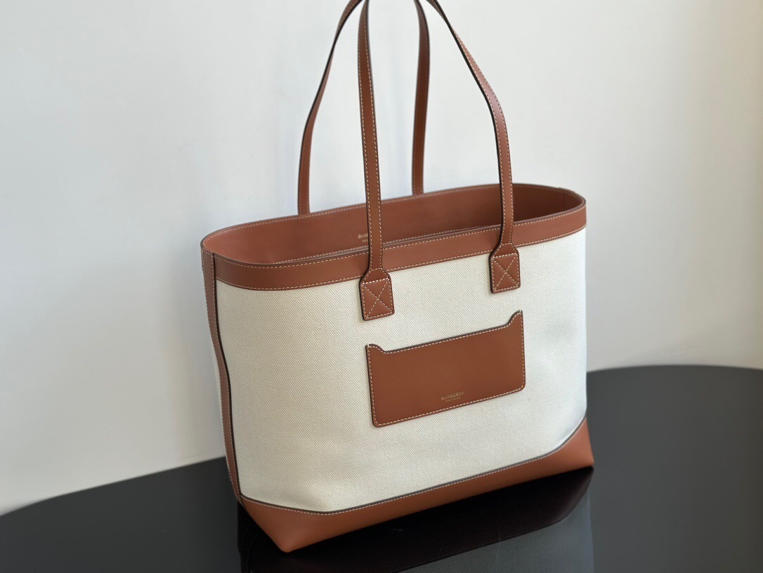 Burberry Cotton with Calfskin Tote Bag, which is also similar to a Hogan embossed-logo canvas tote bag