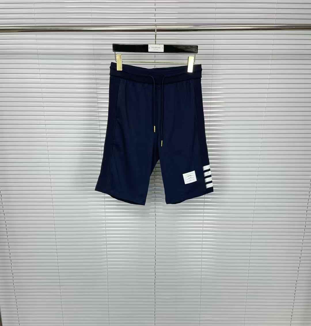 Thom Browne navy 4-Bar striped track shorts with a drawstring waist and a logo patch