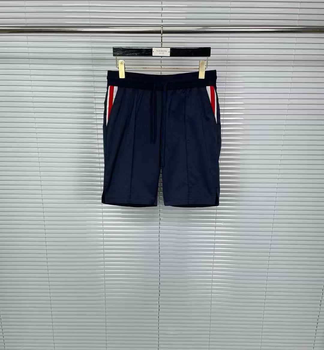 Thom Browne Classic Pique Stripe Shorts in navy blue with signature red, white, and blue side stripes