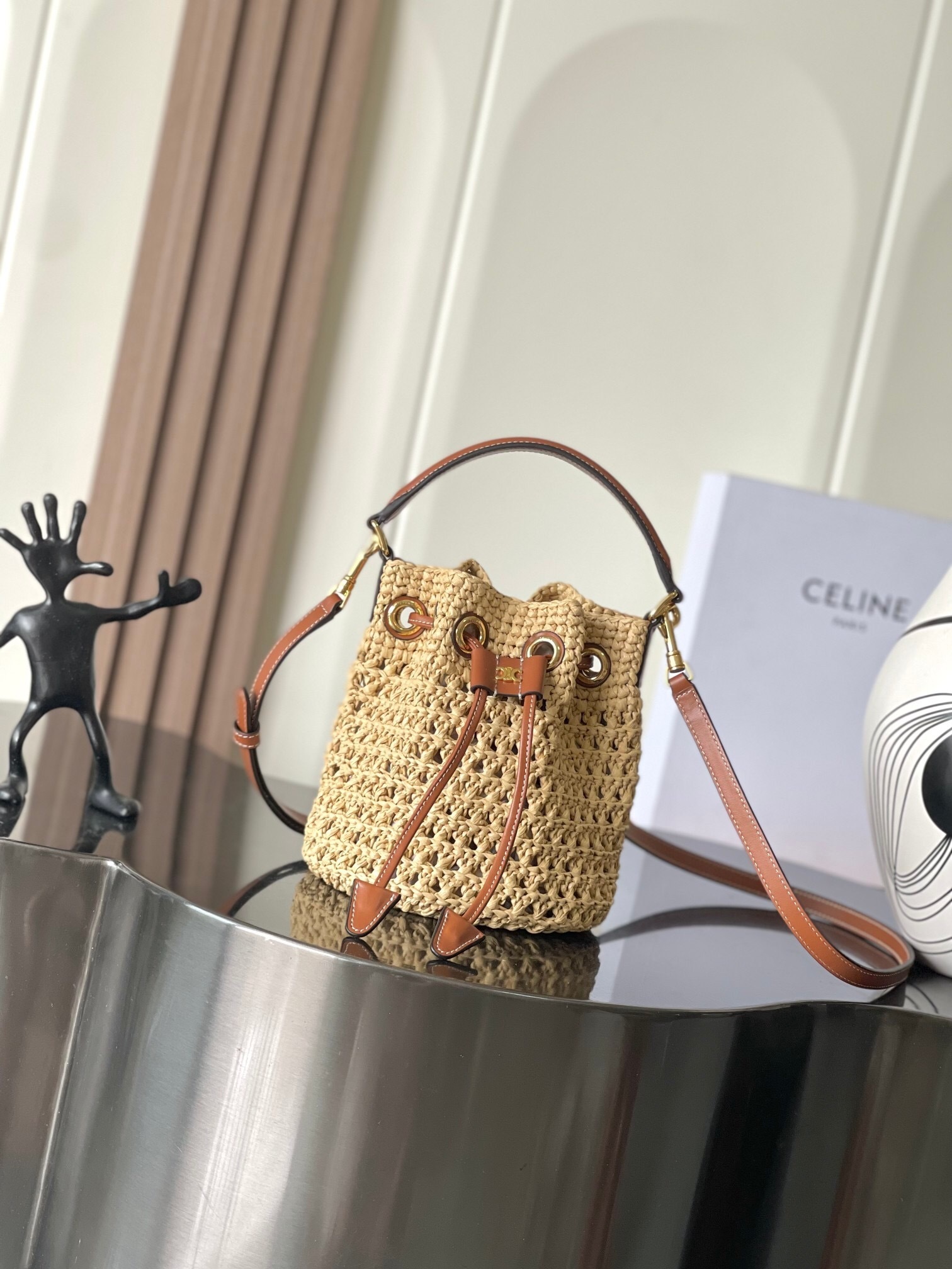 Celine Clara bucket bag in a natural woven raffia material with tan calfskin leather trim